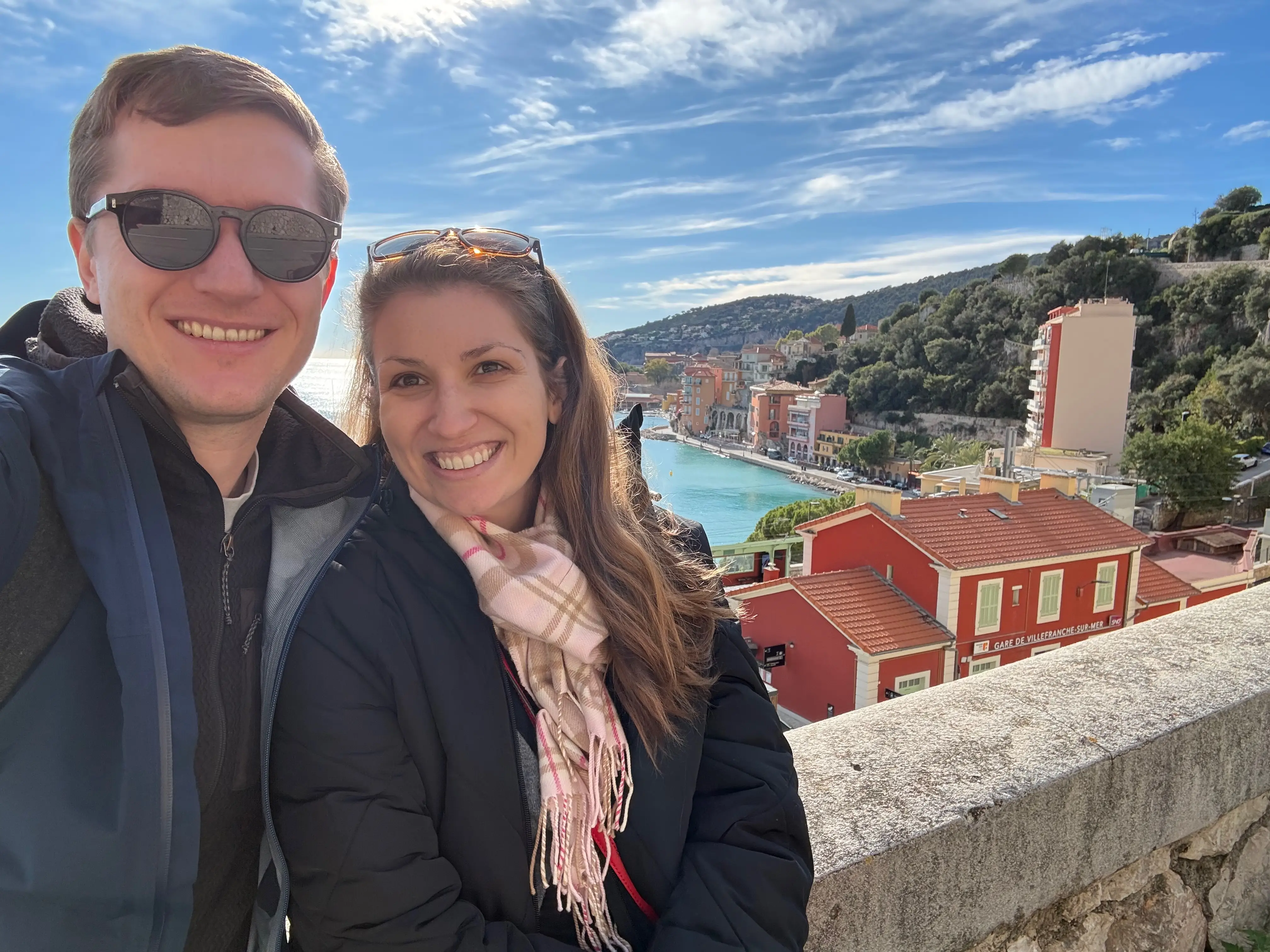 A couple posing with Nice, in the South of France in the background.