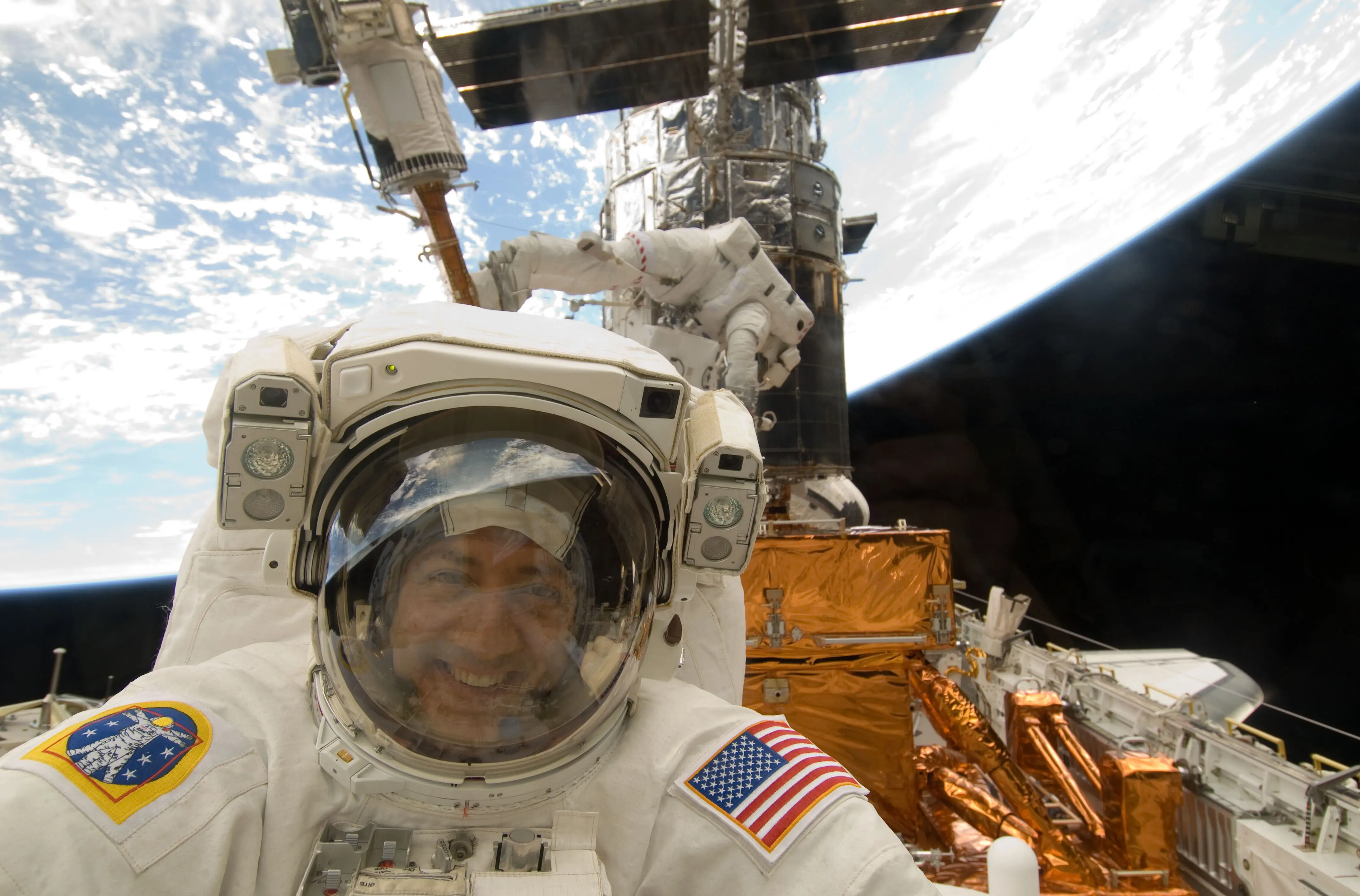 Mike Massimino in space with Earth in the background.