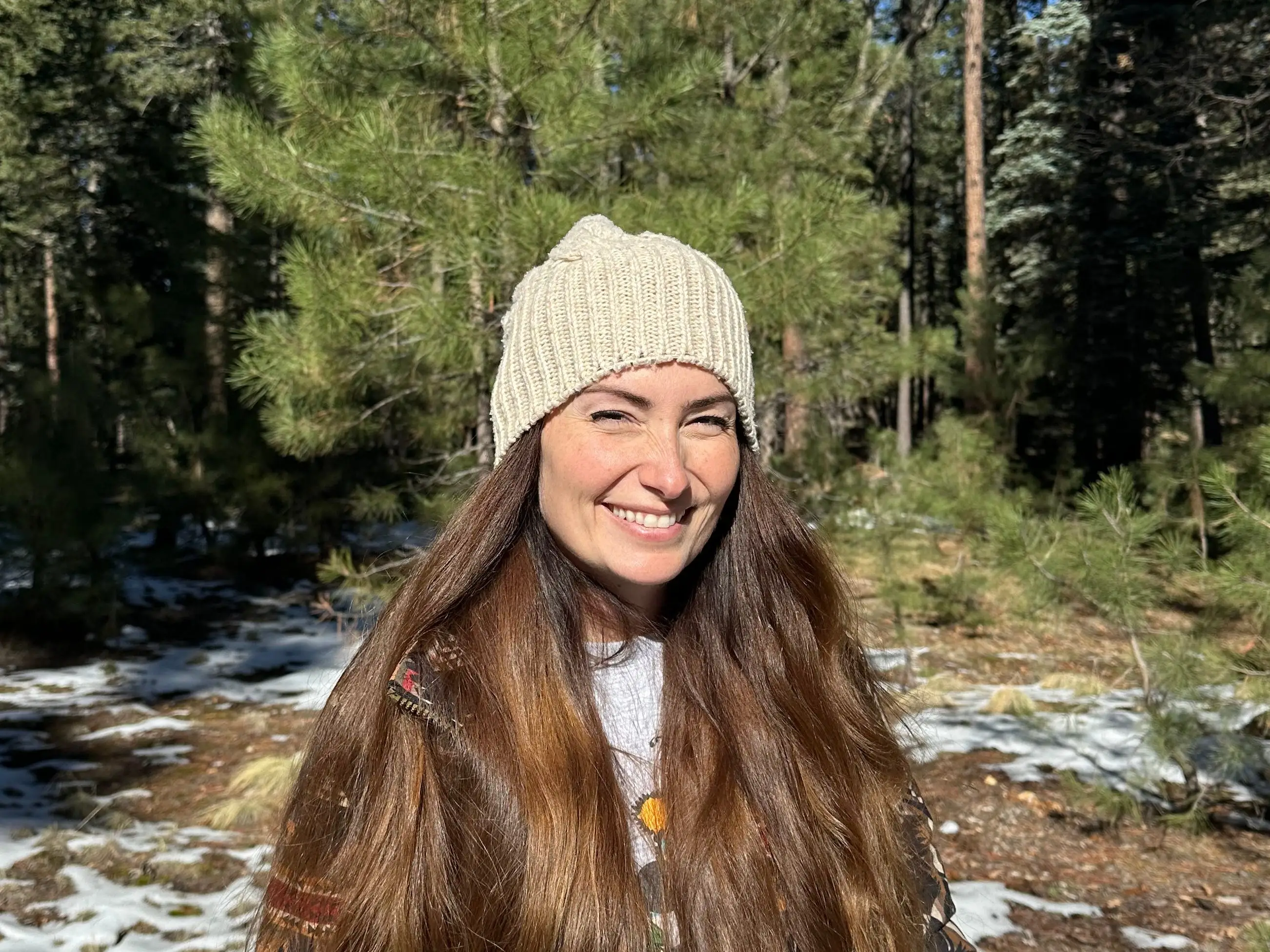 The author wearing a beanie and standing in the snow.