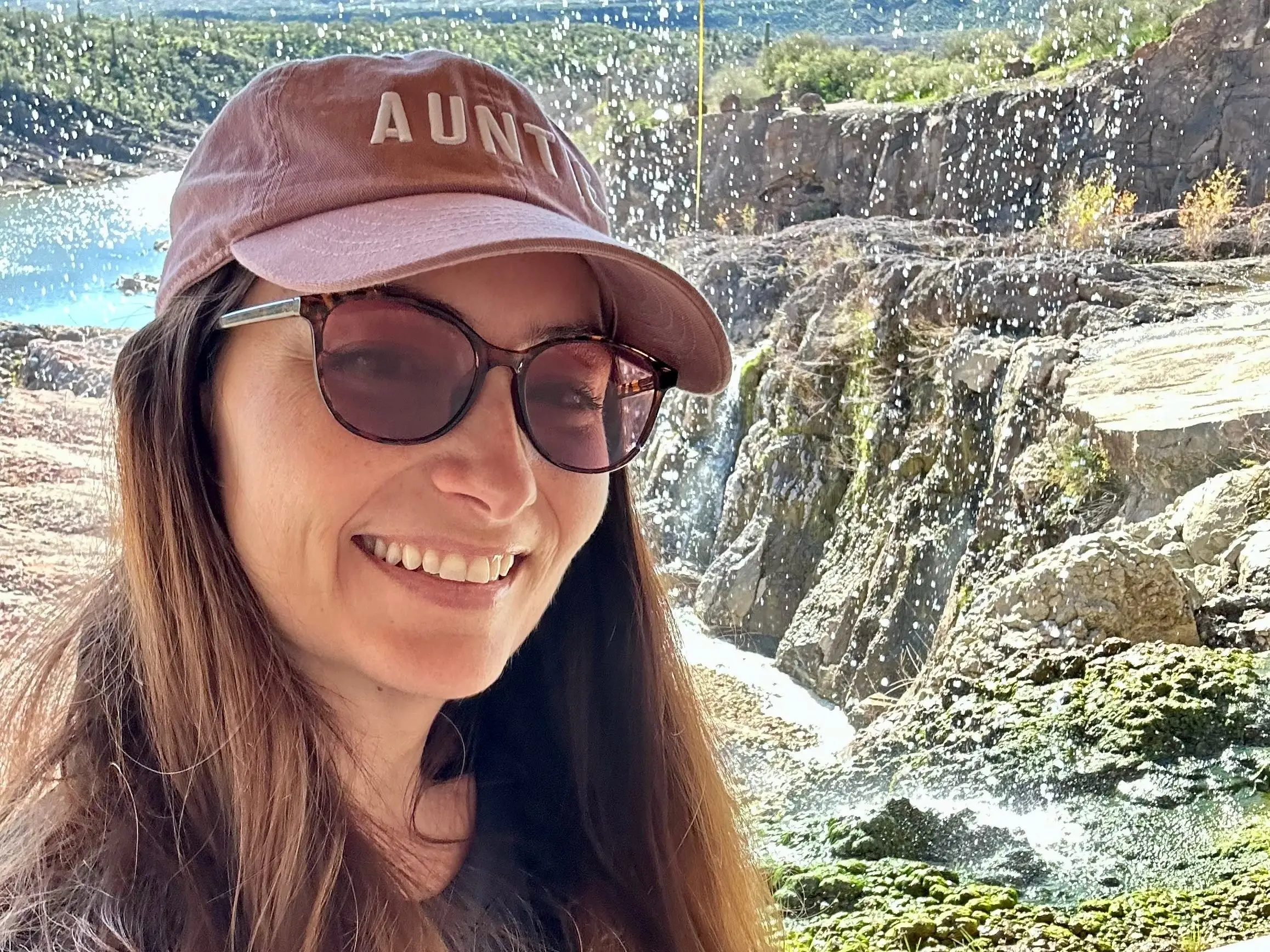 The author wearing a hat that says 'Aunt'
