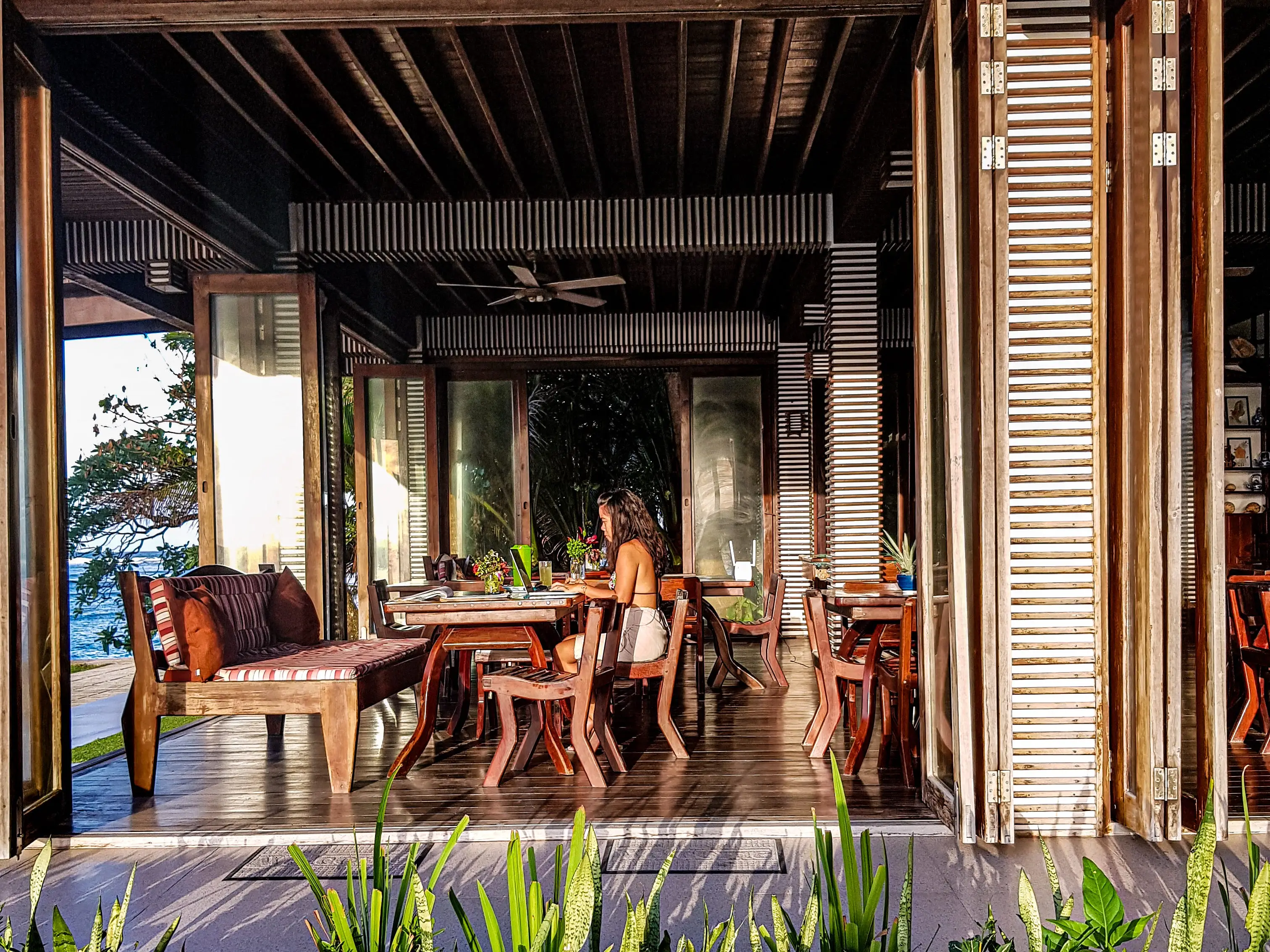 A woman working at a desk outdoors in Siargao, Philippines.