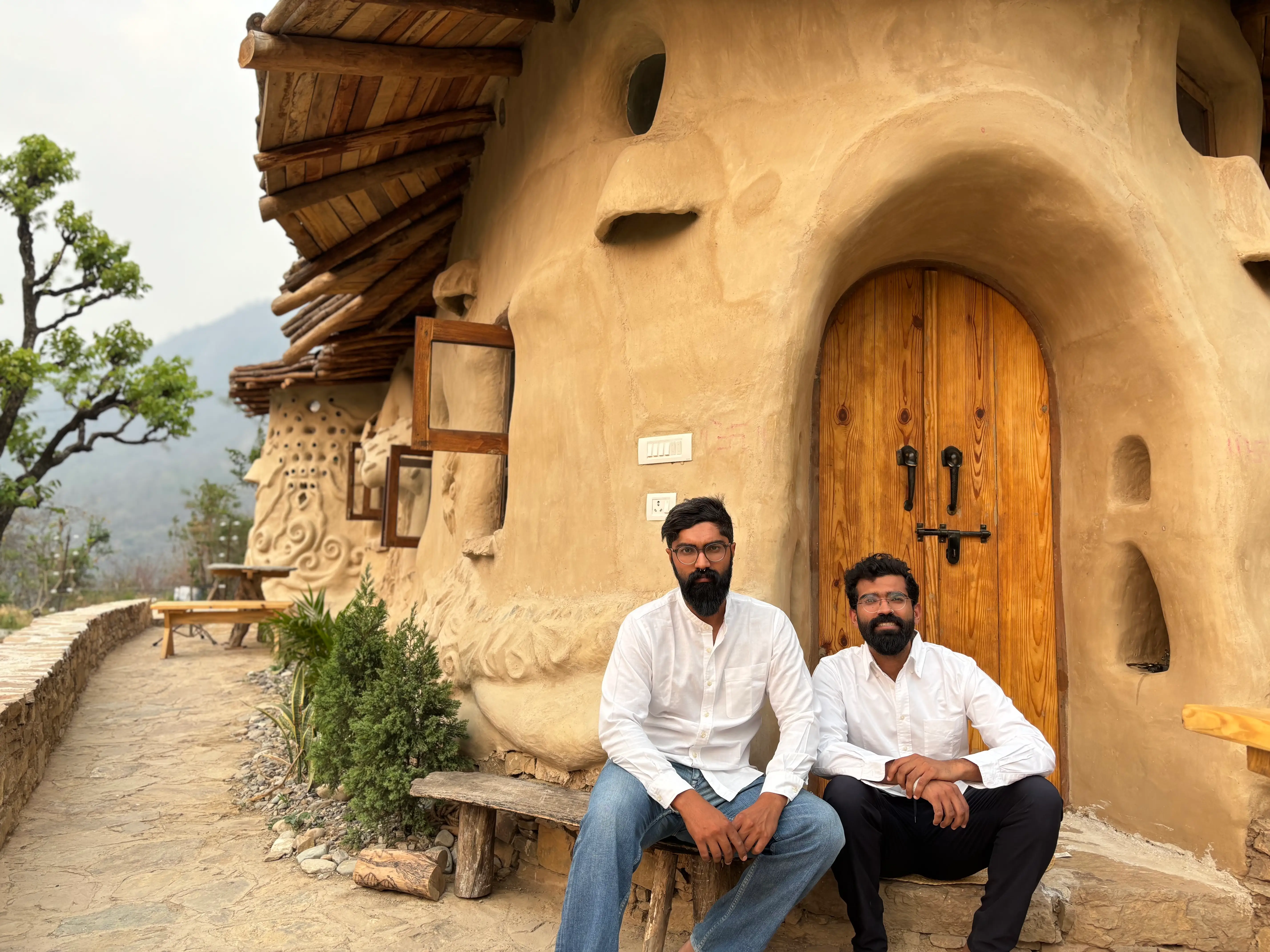 Raghav and Ansh Kumar, in front of the house they built.