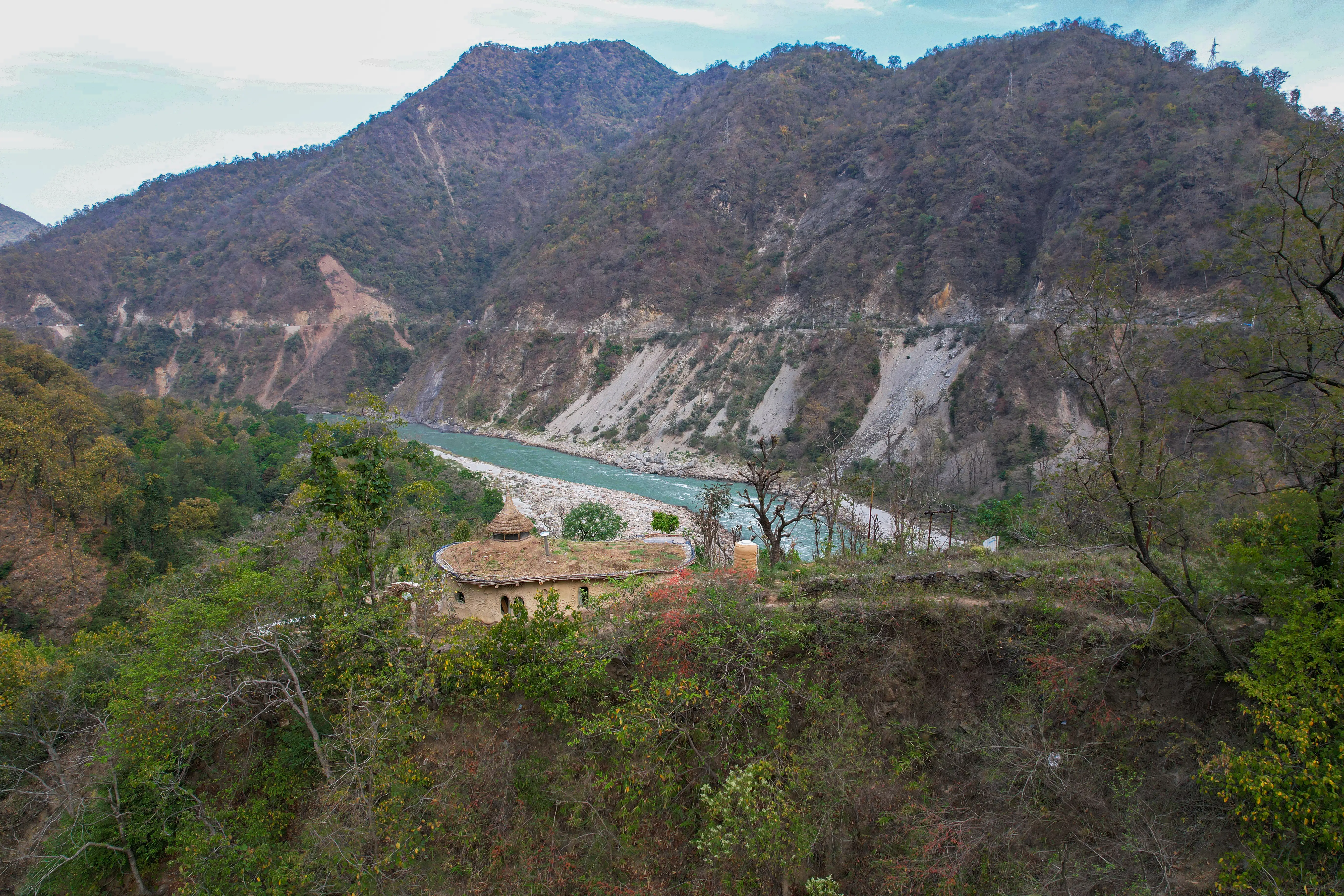 The house that the brothers made, overlooking a river and mountains.
