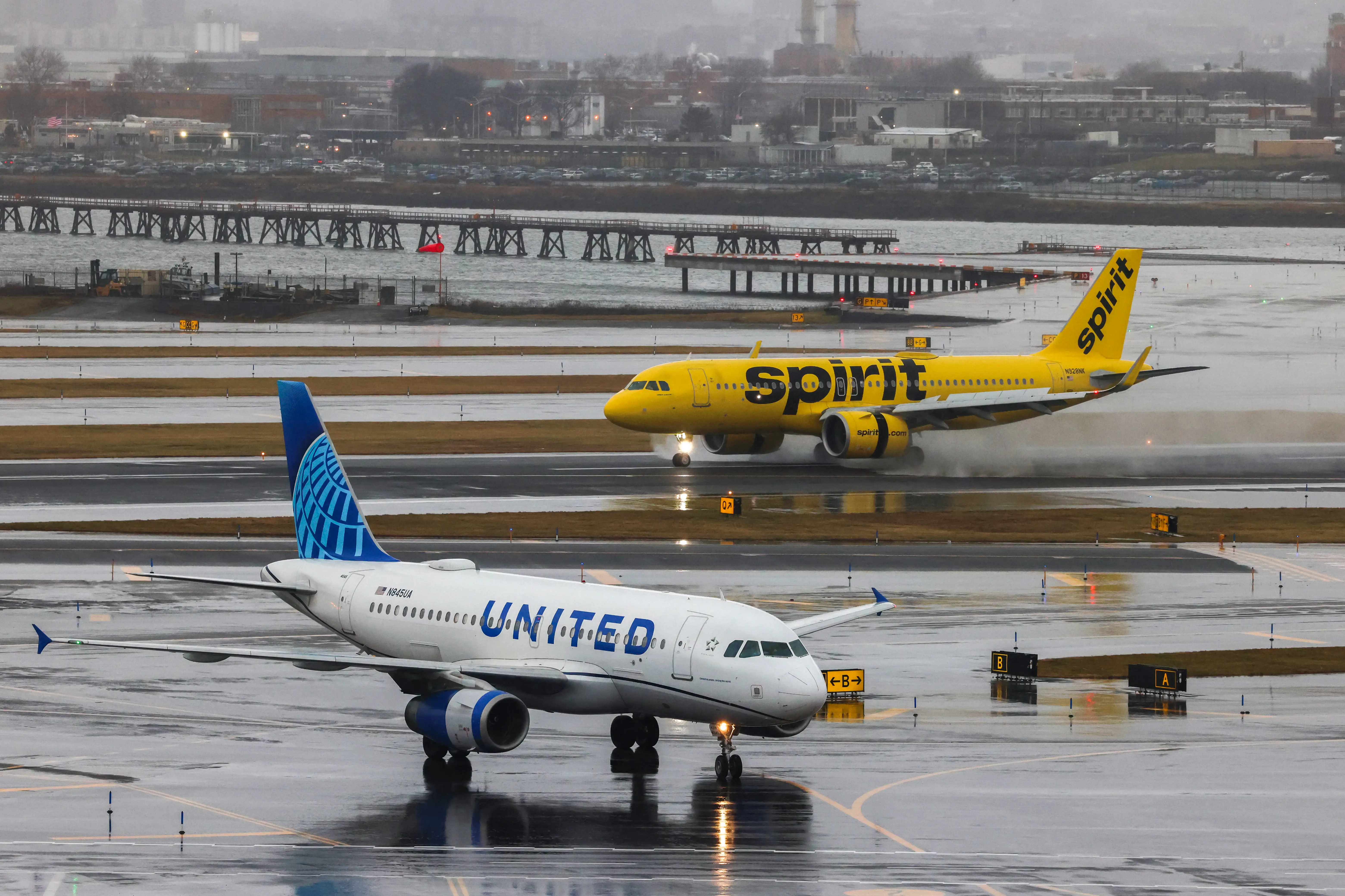 An Airbus A320 passengers aircraft of Spirit airlines arriving from Miamia is pictured while an Airbus A319 of United airlines arrived from Denver are seen at La Guardia Airport on January 9, 2024.