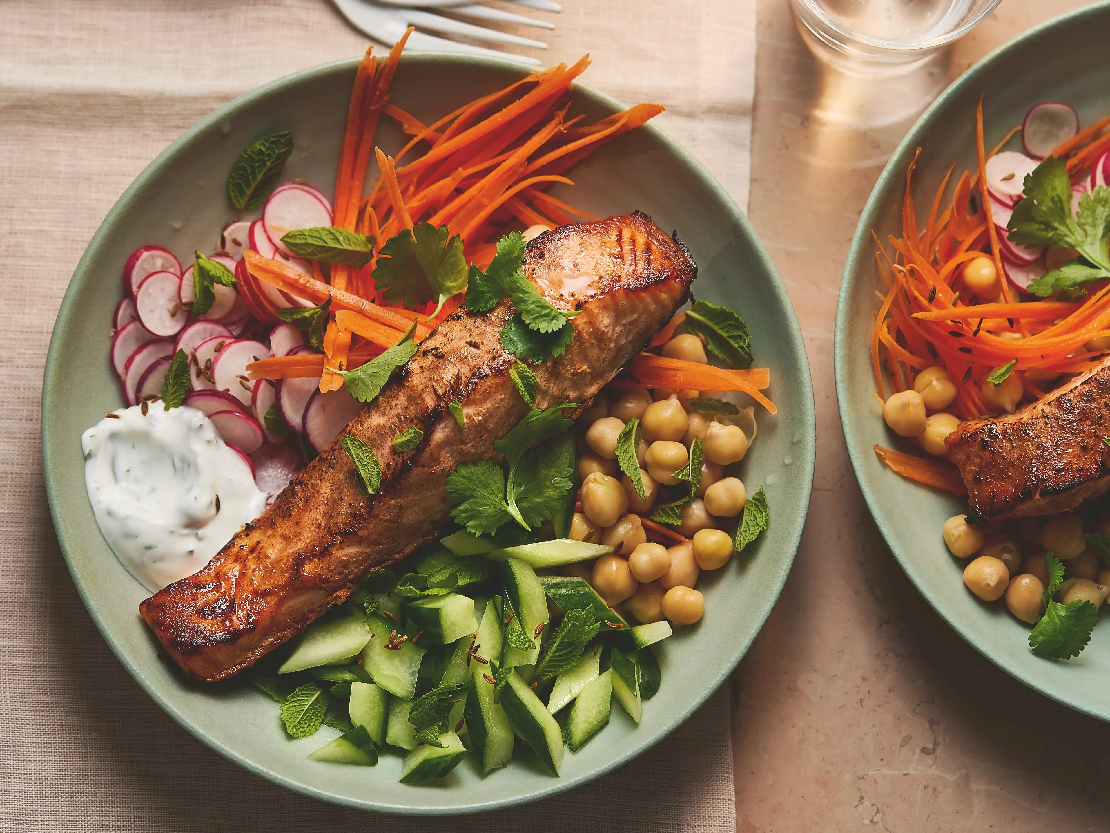 A bowl of baked salmon and veggies.