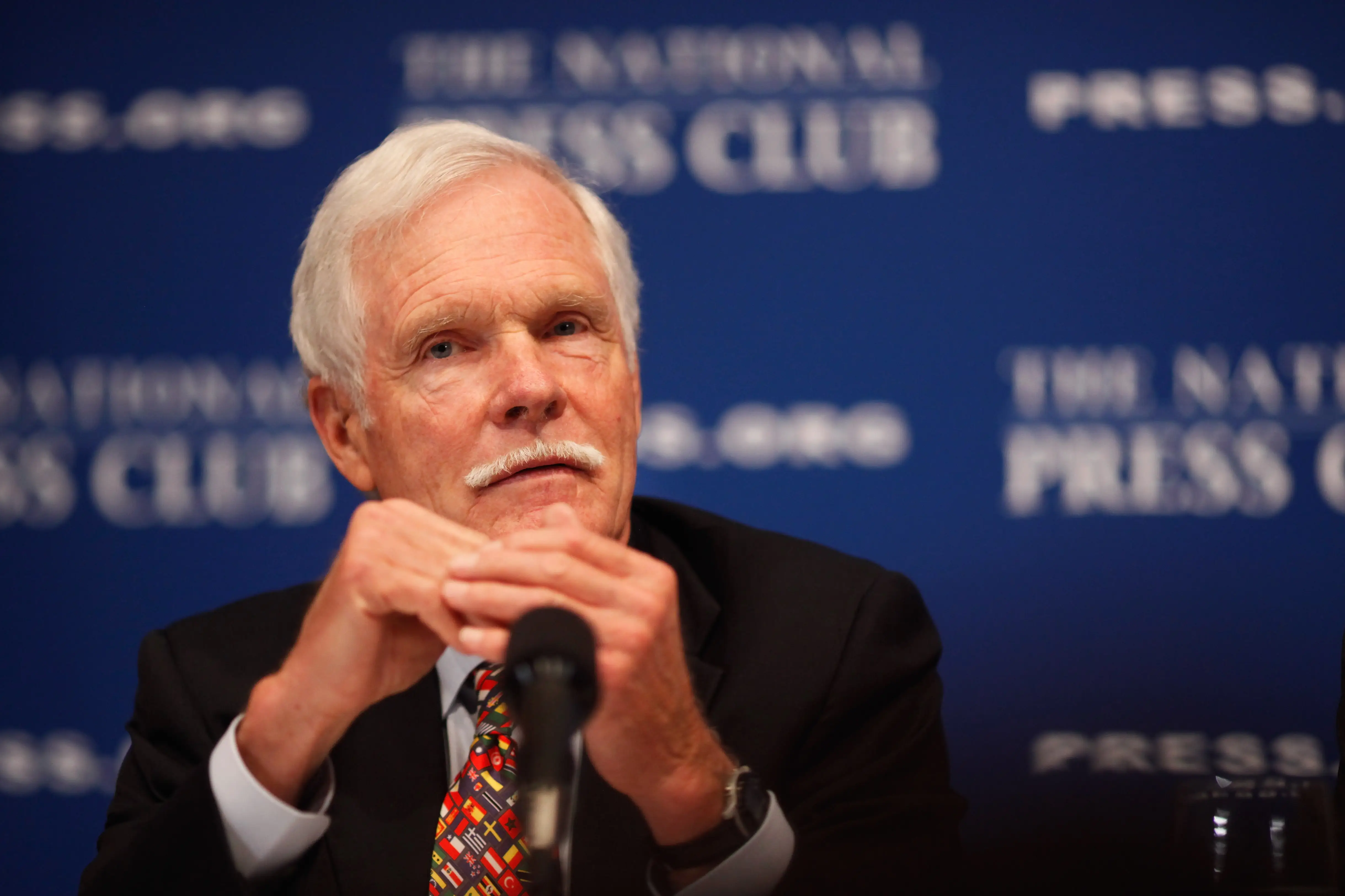 Ted Turner in a suit and tie
