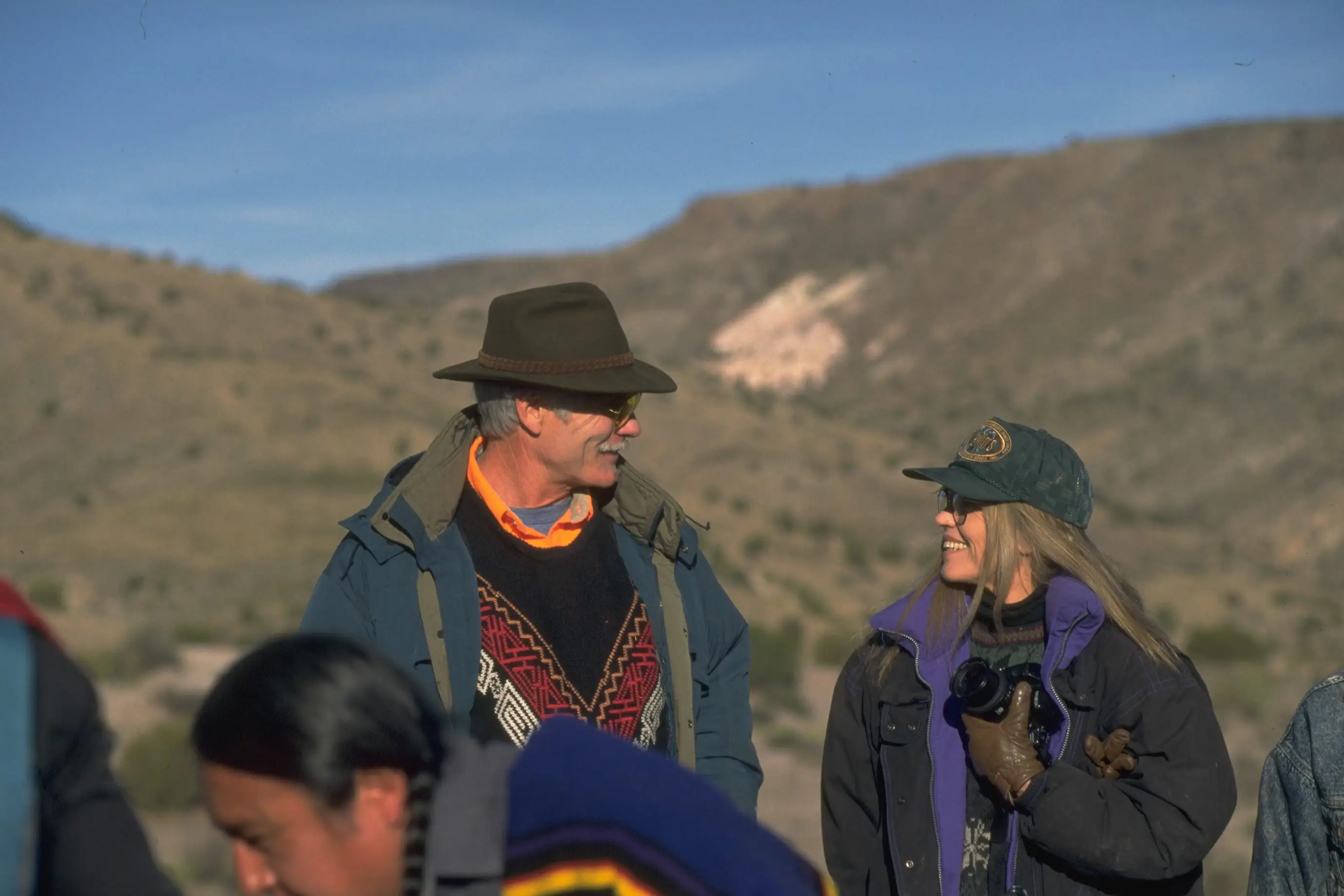 Ted Turner and Jane Fonda smile at each other during a conservation education exercise with a Native American tribe.