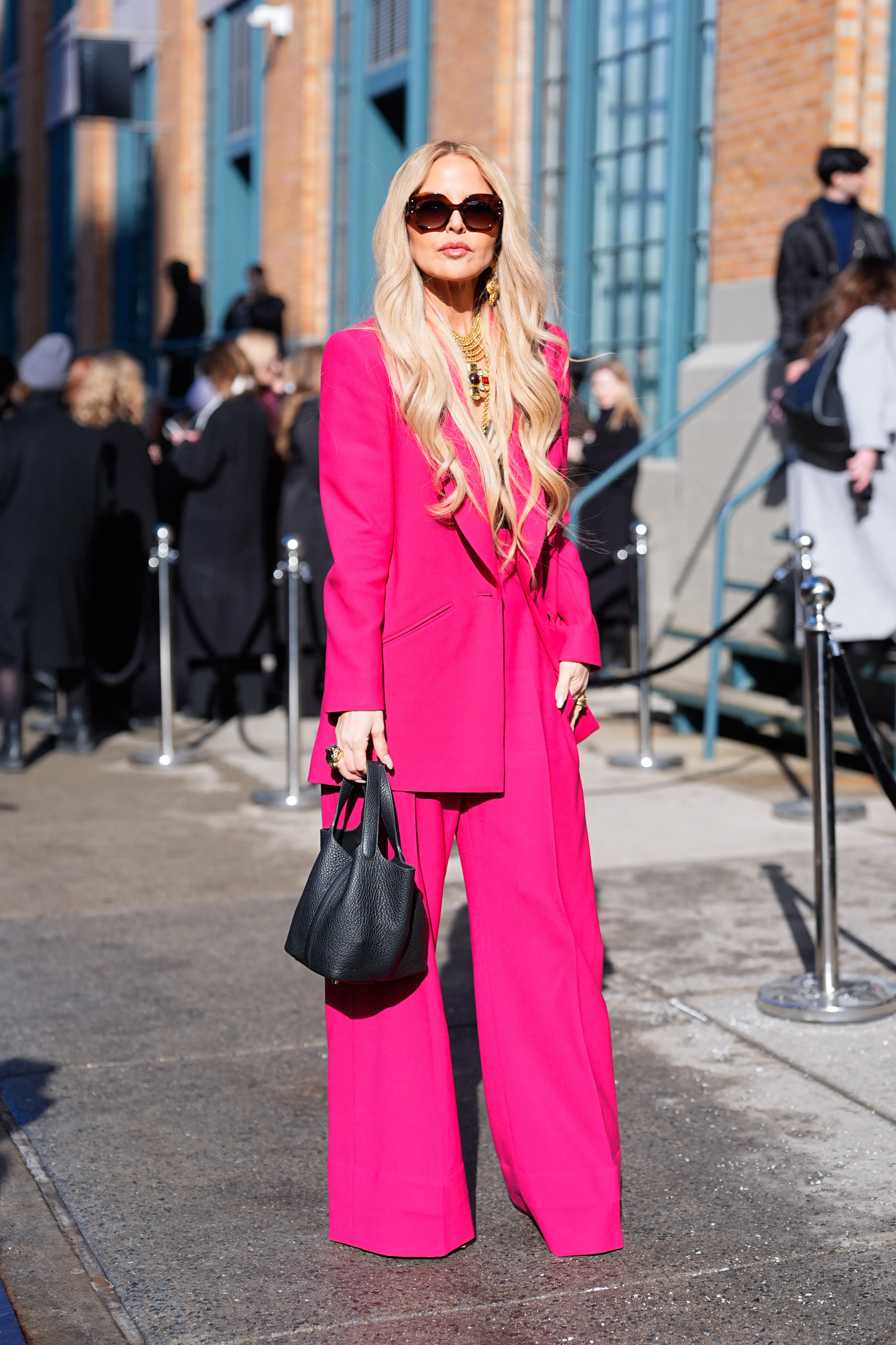 Rachel Zoe wearing a hot pink suit on a New York City street.