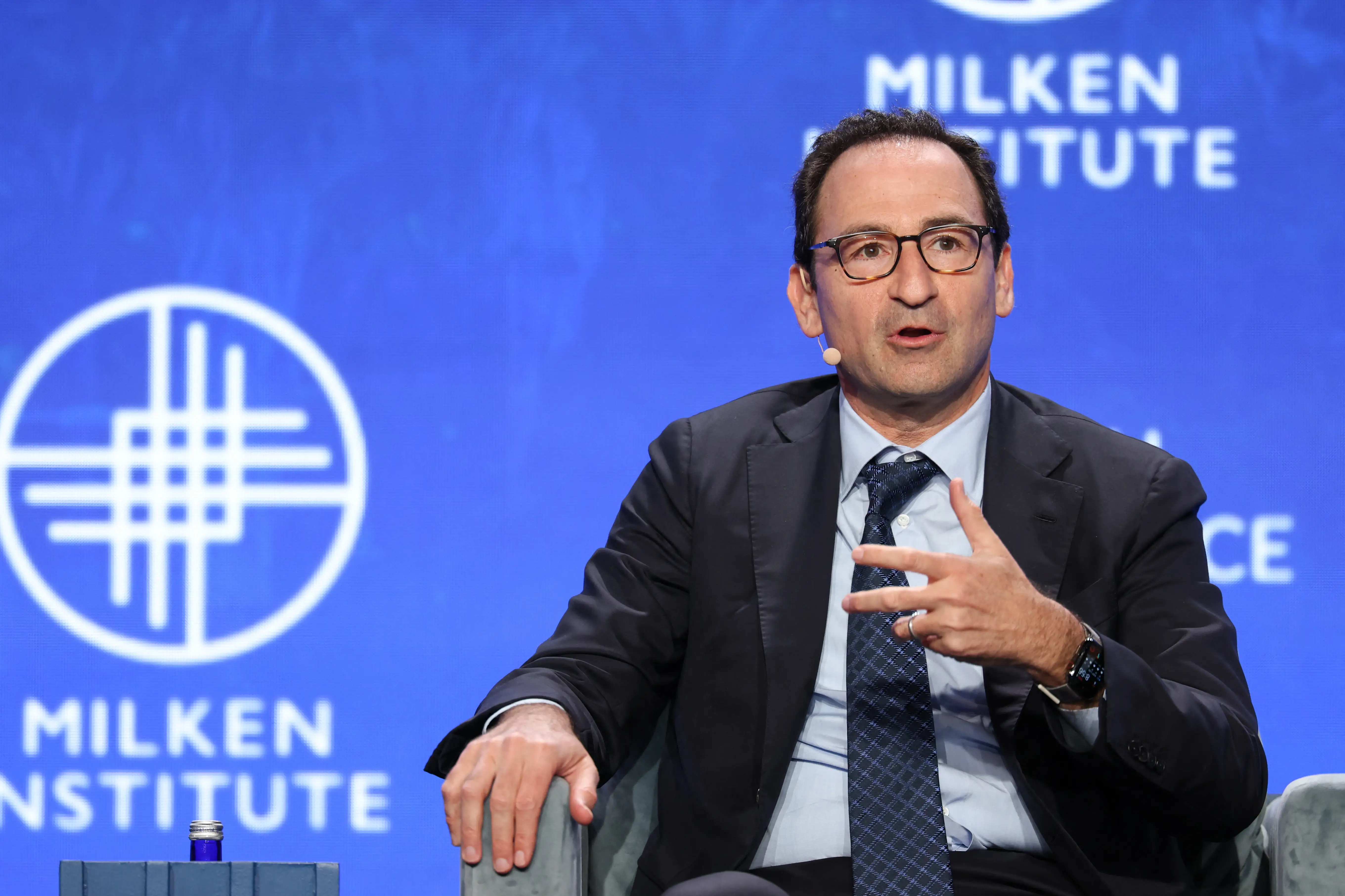 Jon Gray speaks onstage at the Milken conference