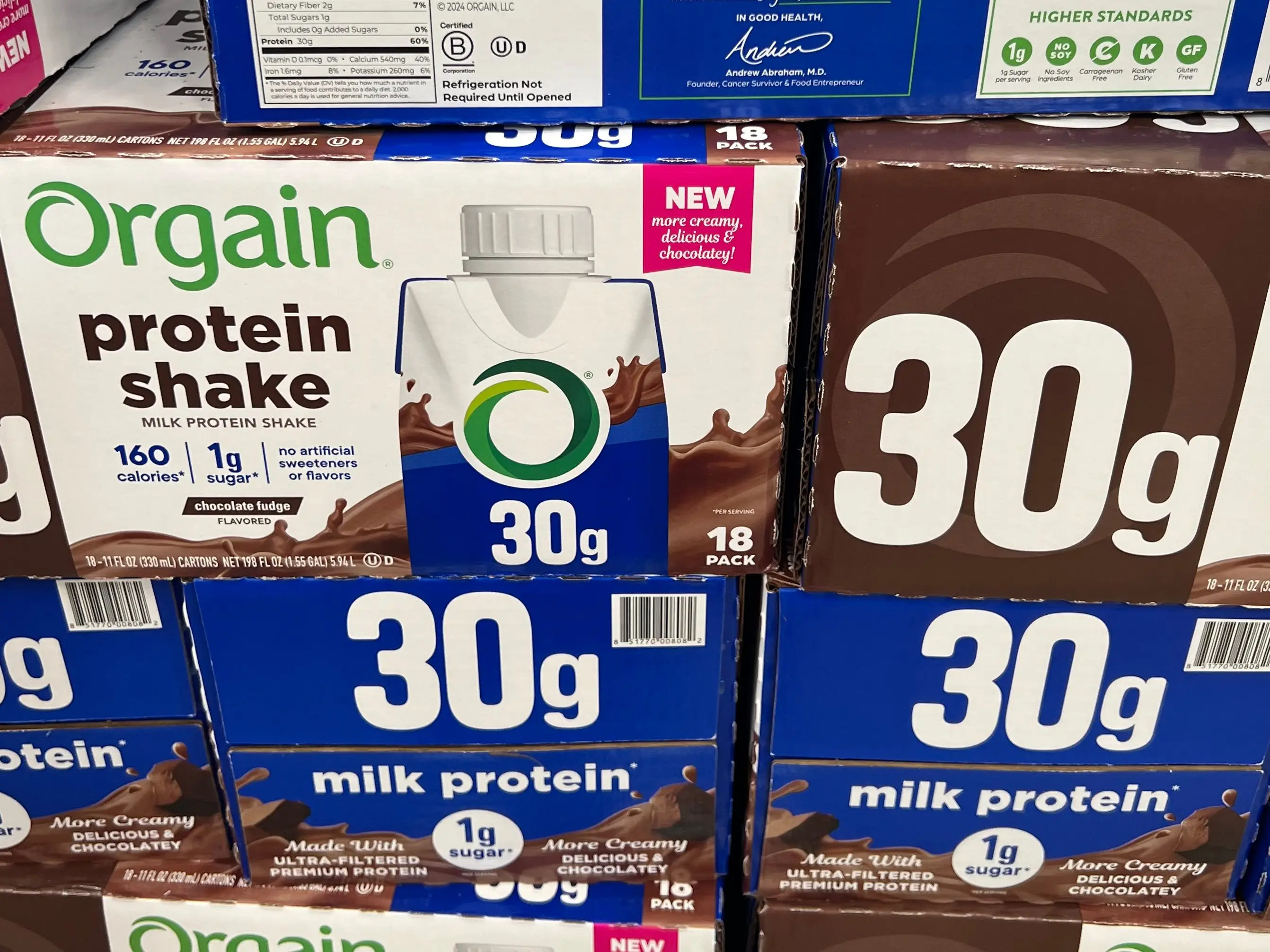 Several boxes of Orgain chocolate-fudge protein shakes.