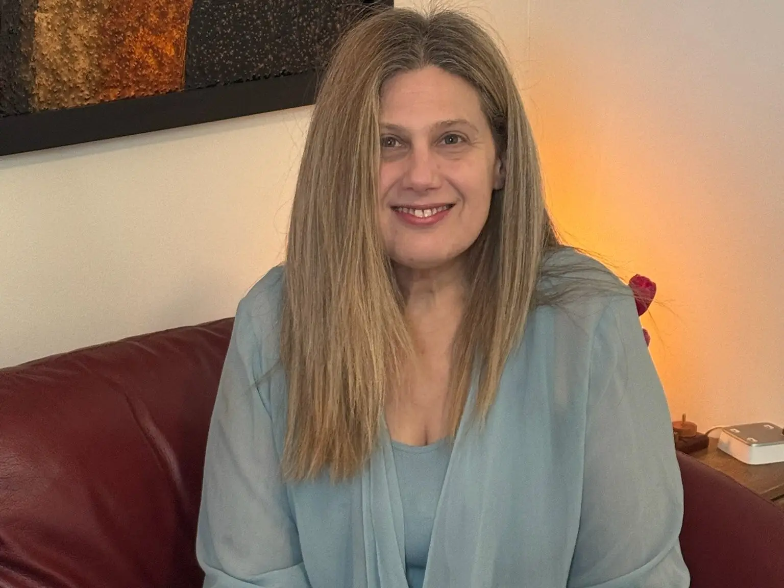 A woman sitting on a sofa holding a book
