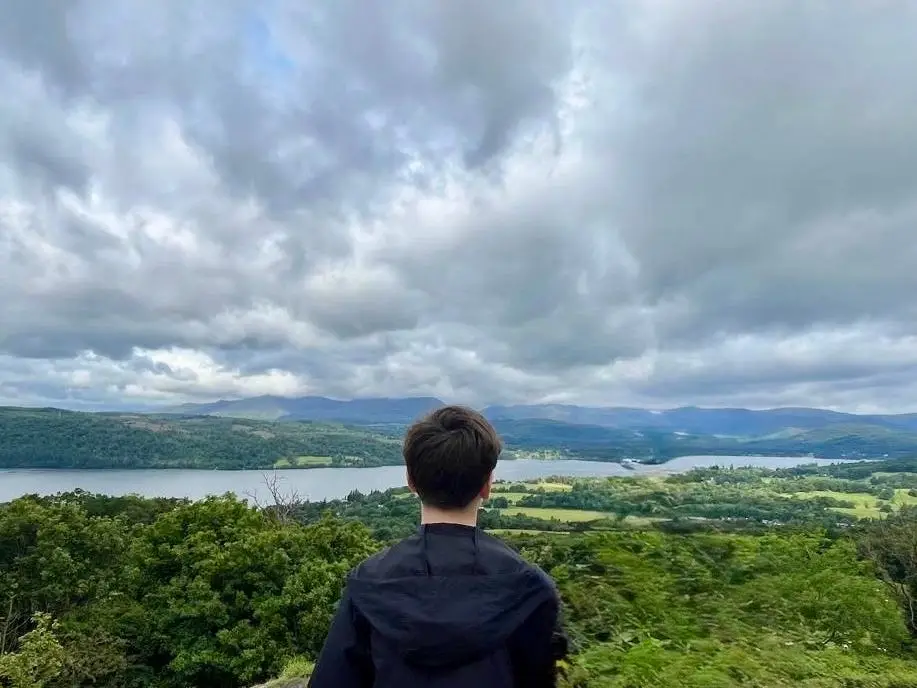 The author's son looking out at a view while on a hike.