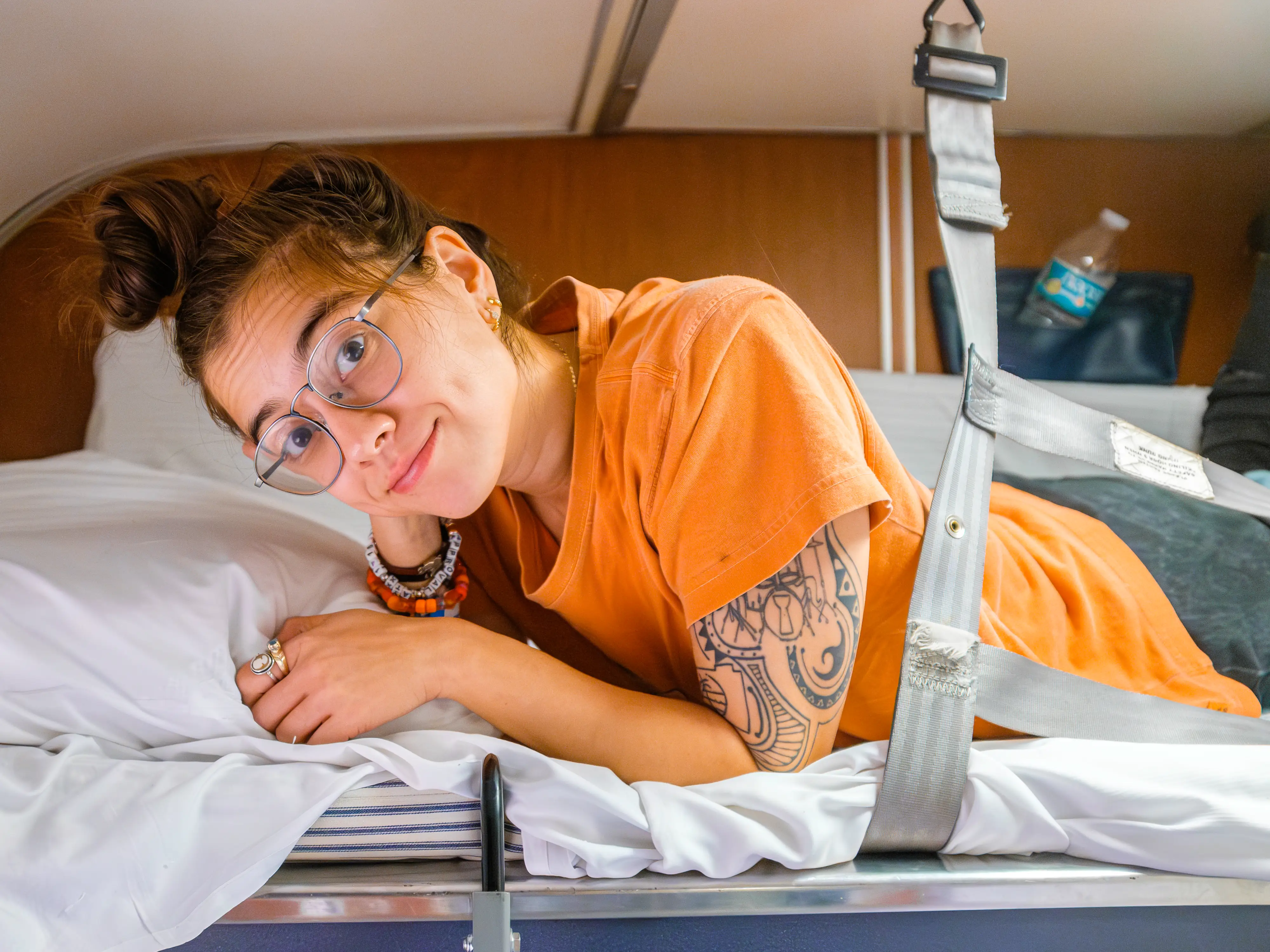 The author lays smiling in the top bunk in the Amtrak bedroom