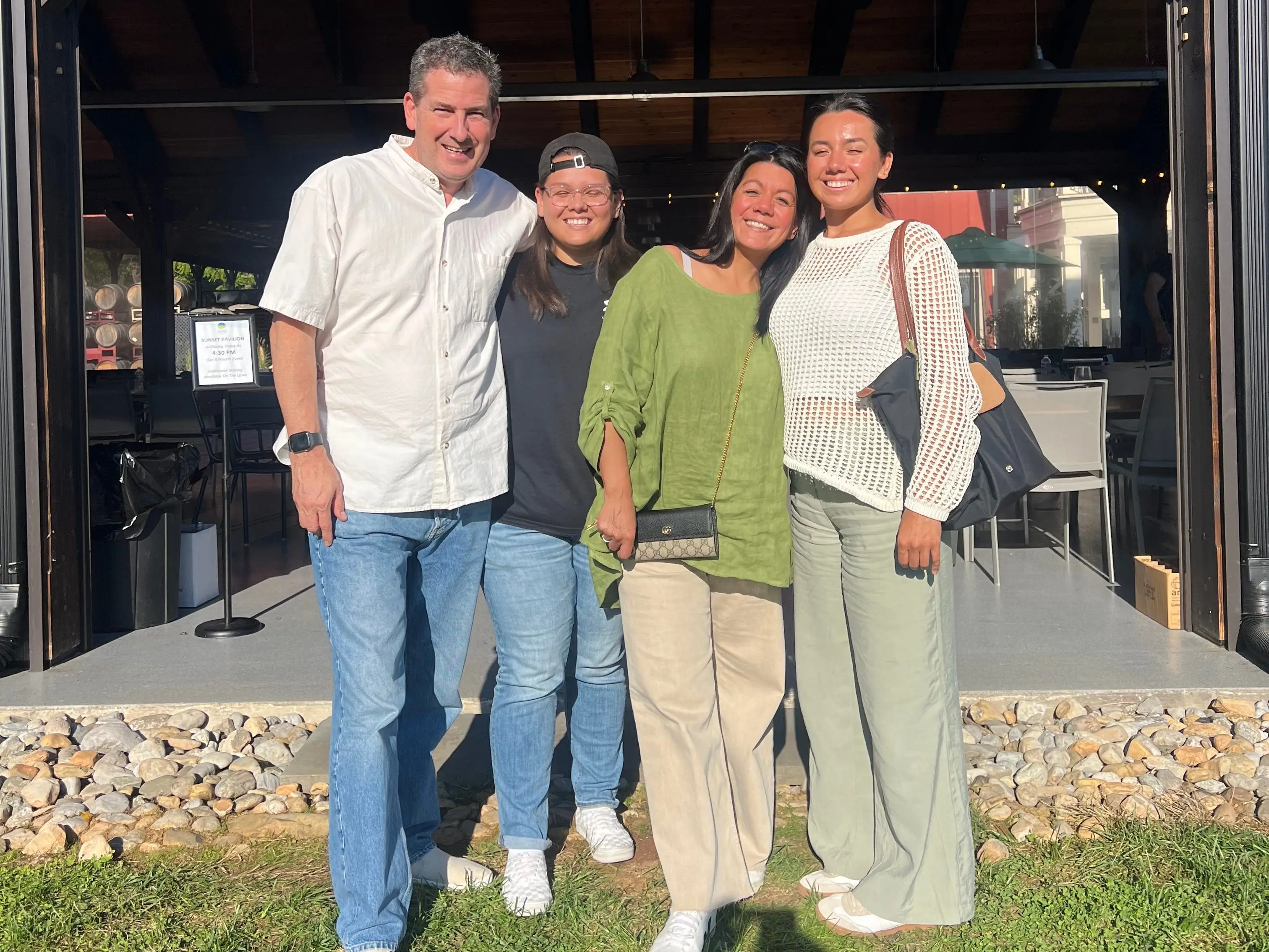 A family of four pose for a picture at a resturant.