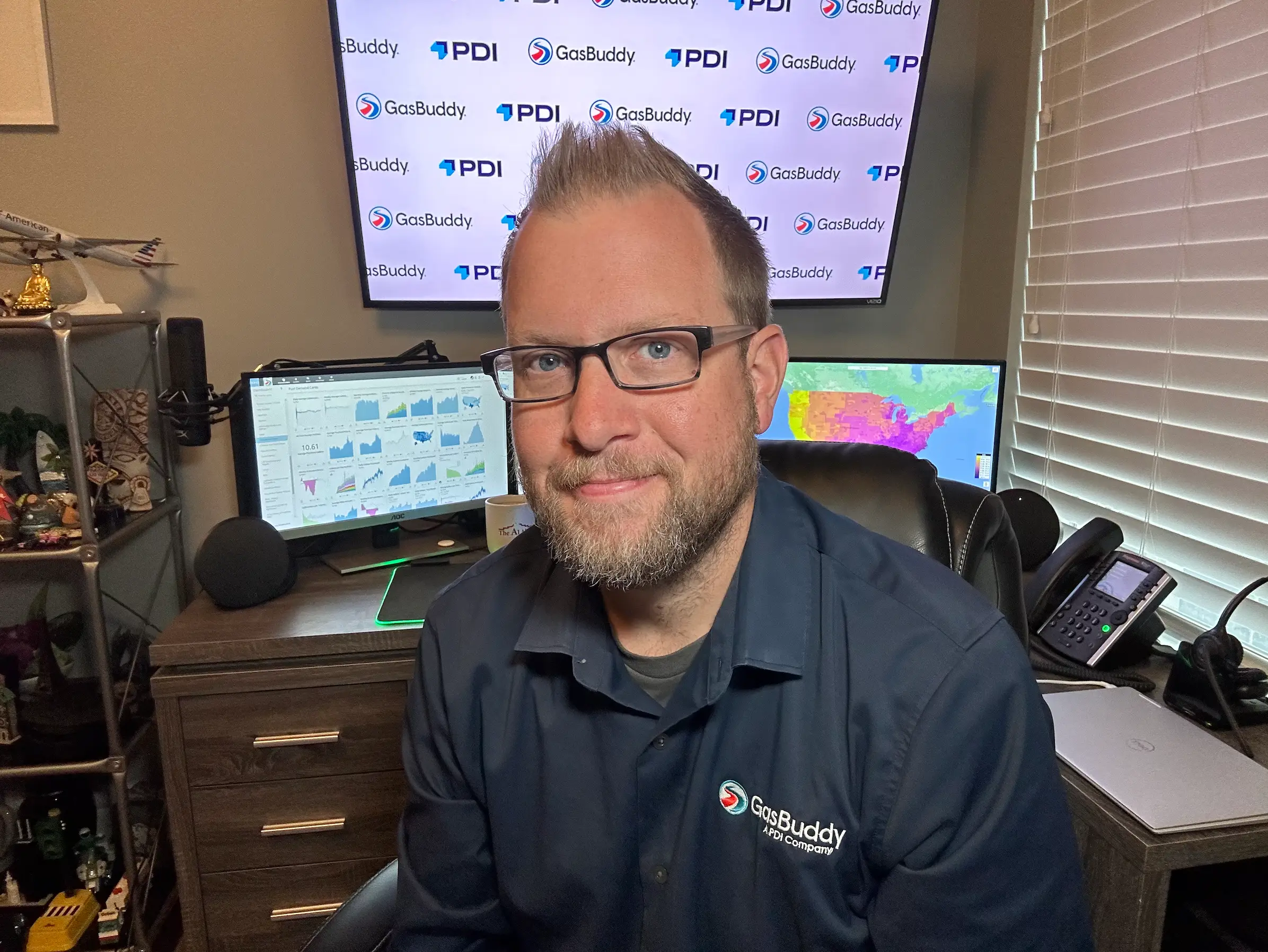 Patrick De Haan, a fuel market expert at GasBuddy, sits at his desk with several computer monitors.