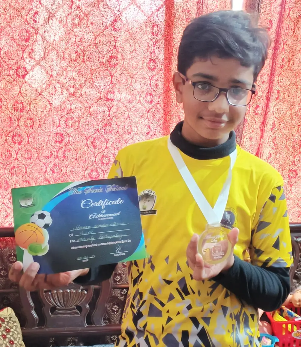 The author;s son models a sporting award he received.