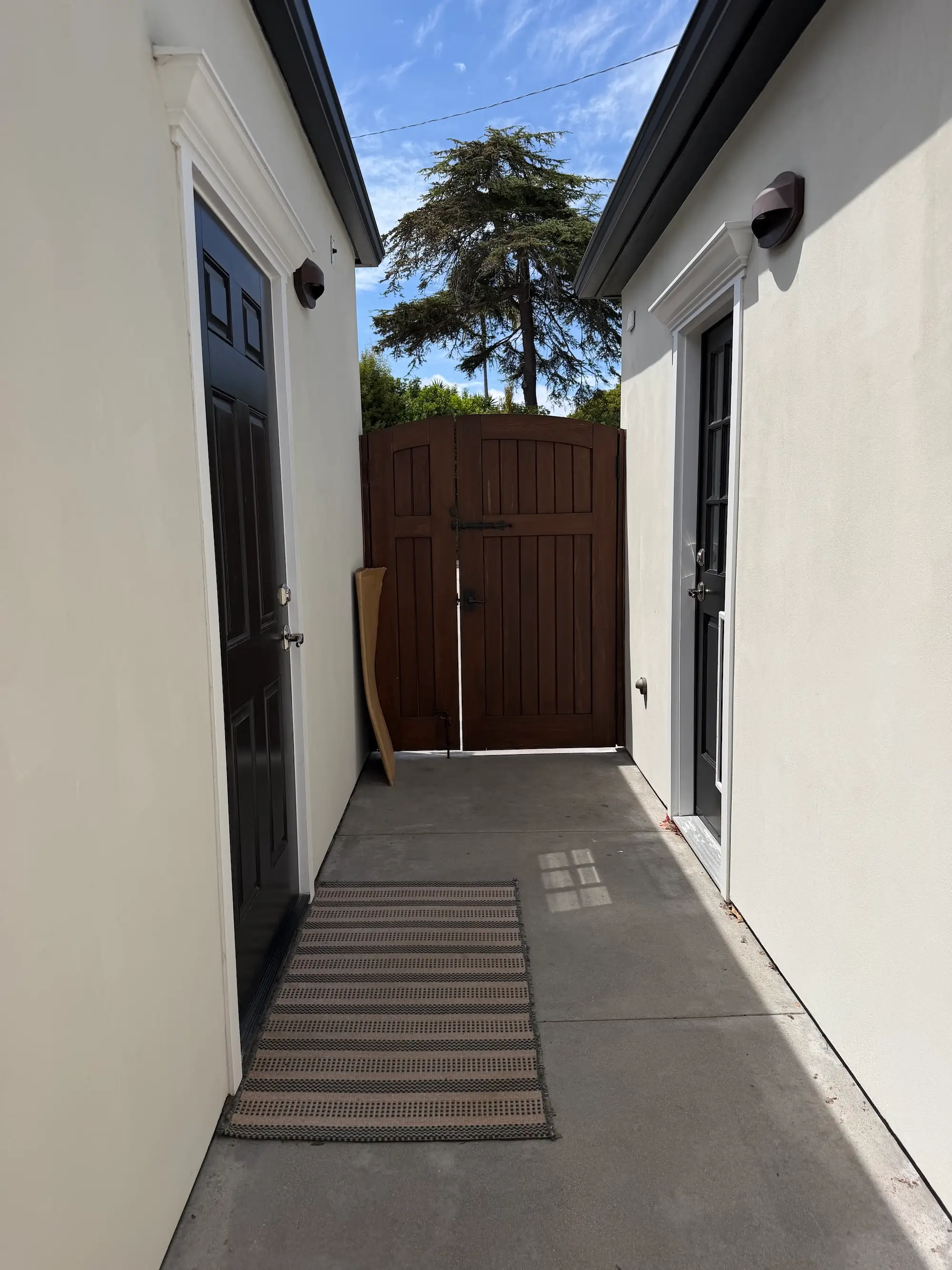 A walkway between an unattached garage and a house.