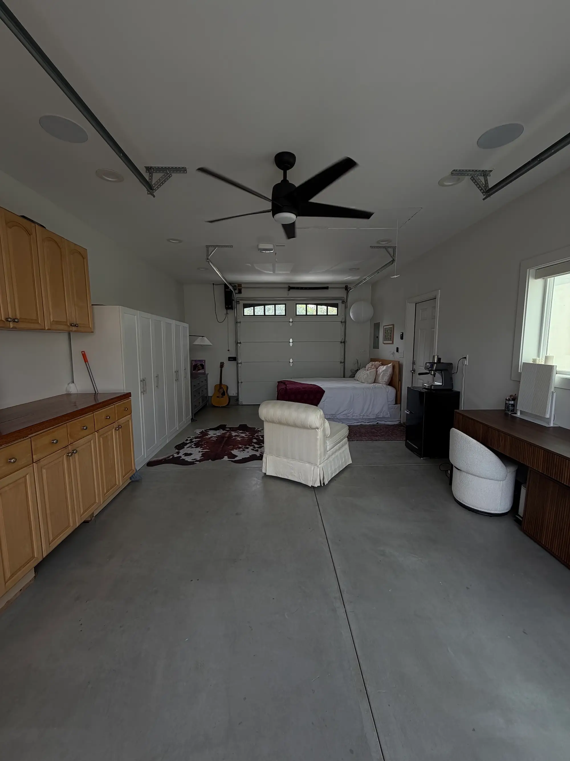 A bedroom and living area inside of a garage.