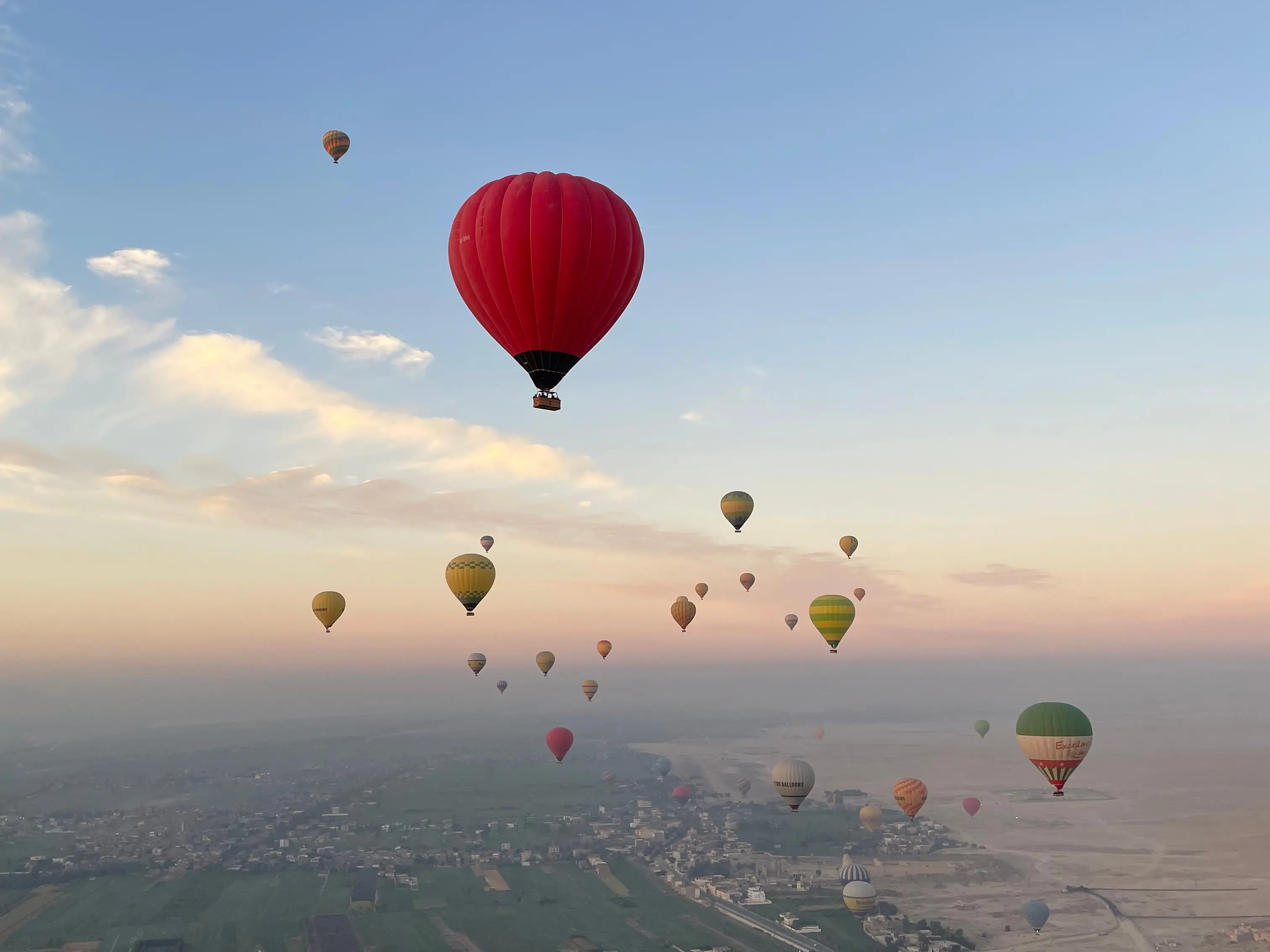 Hot-air balloons floating in the sky in Luxor, Egypt.