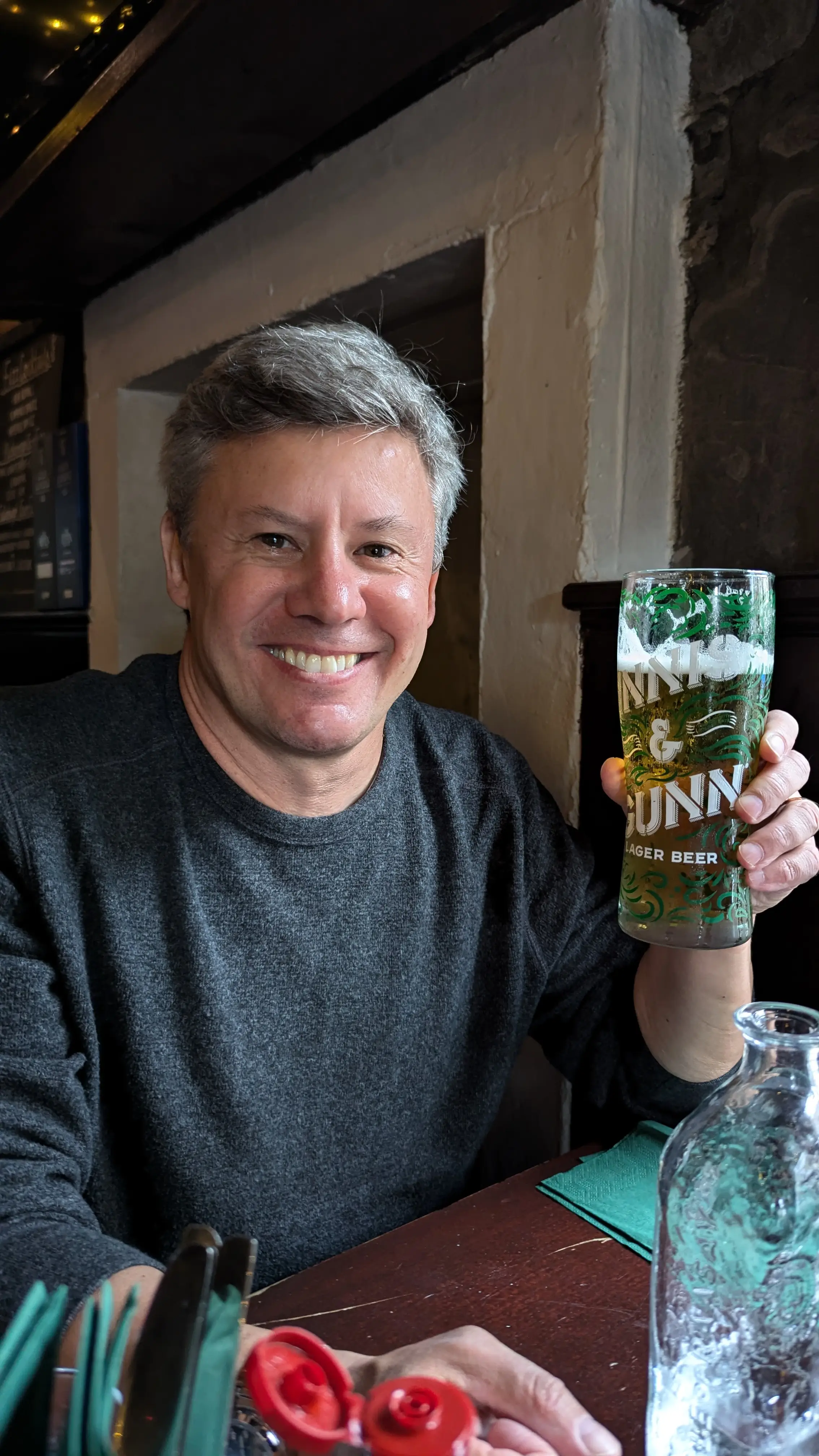 Lowrie is holding a pint of beer.