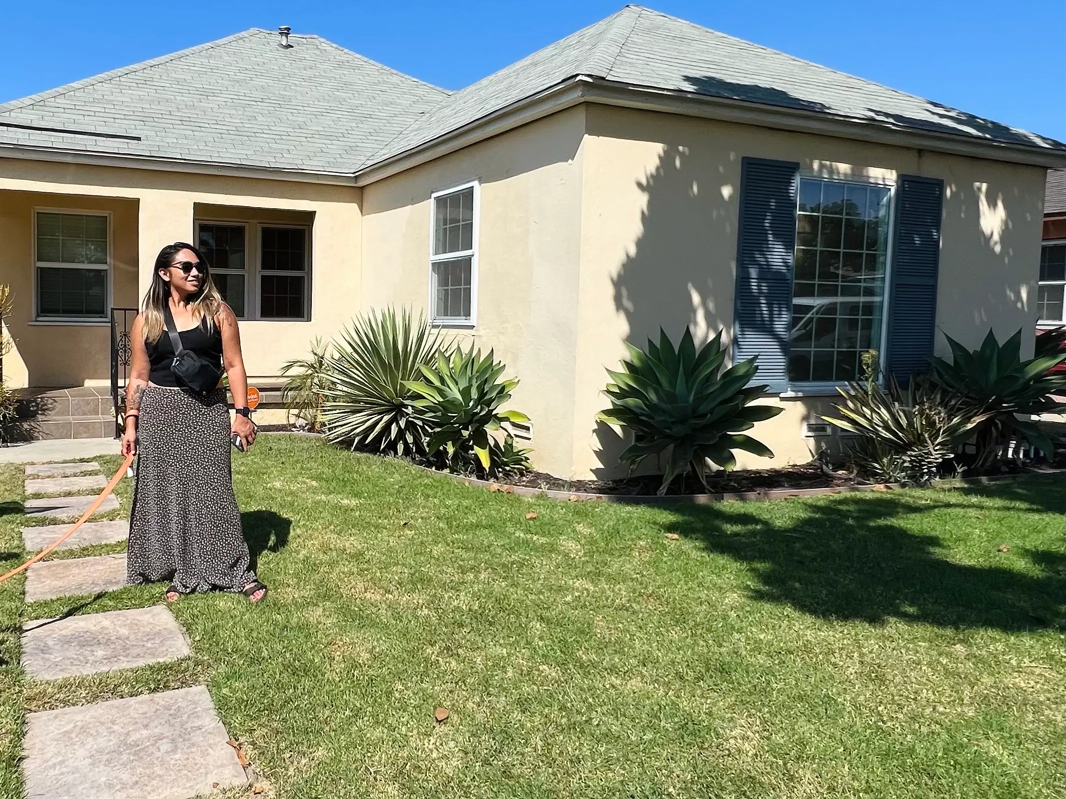 Woman standing outside of house