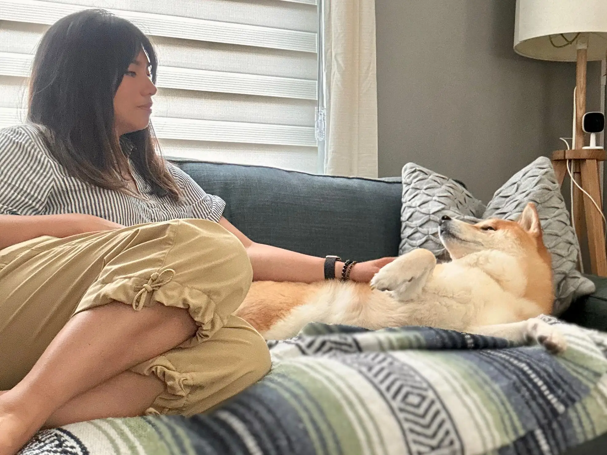 Woman sitting on couch with dog
