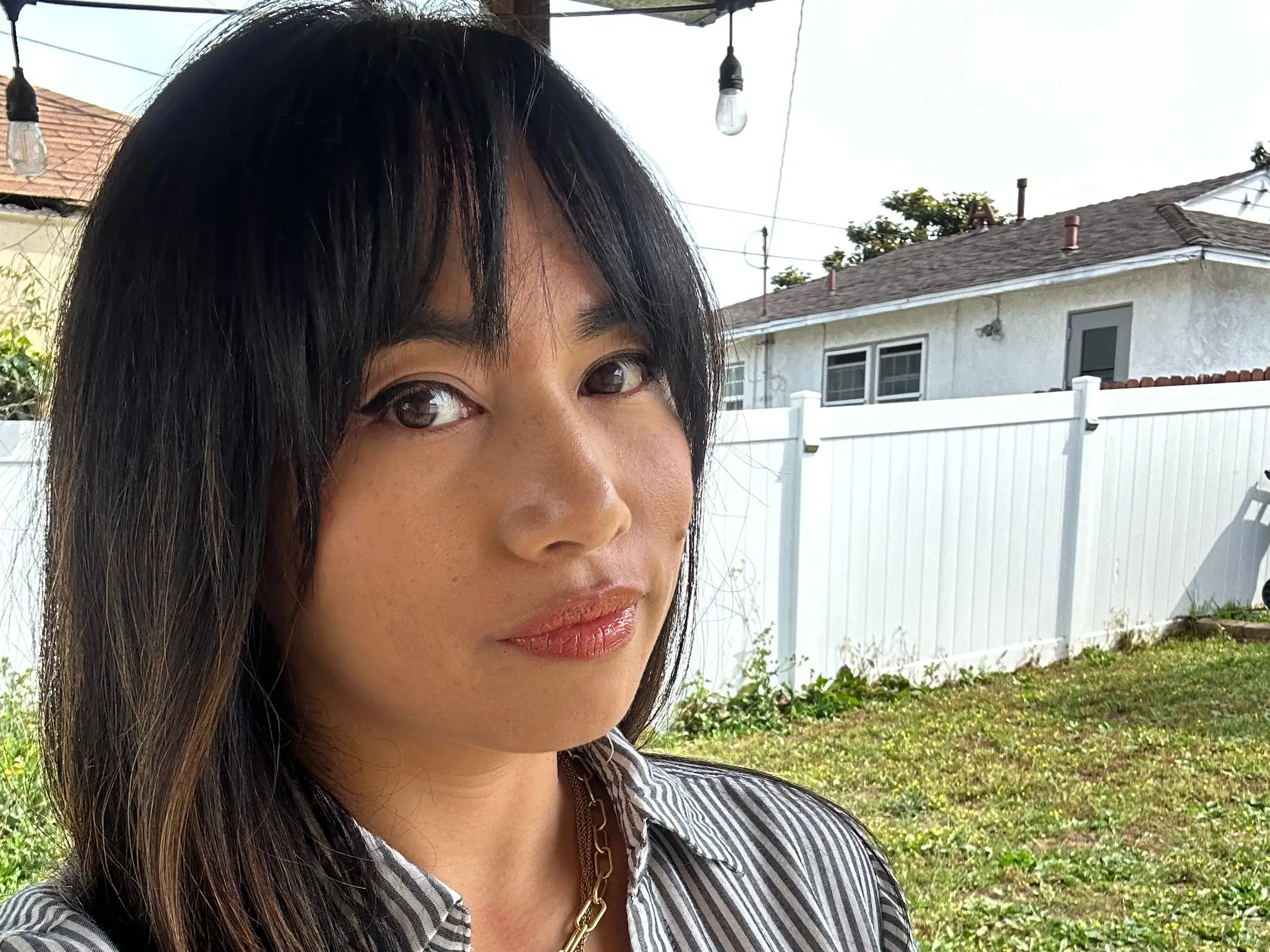 Woman taking selfie in yard
