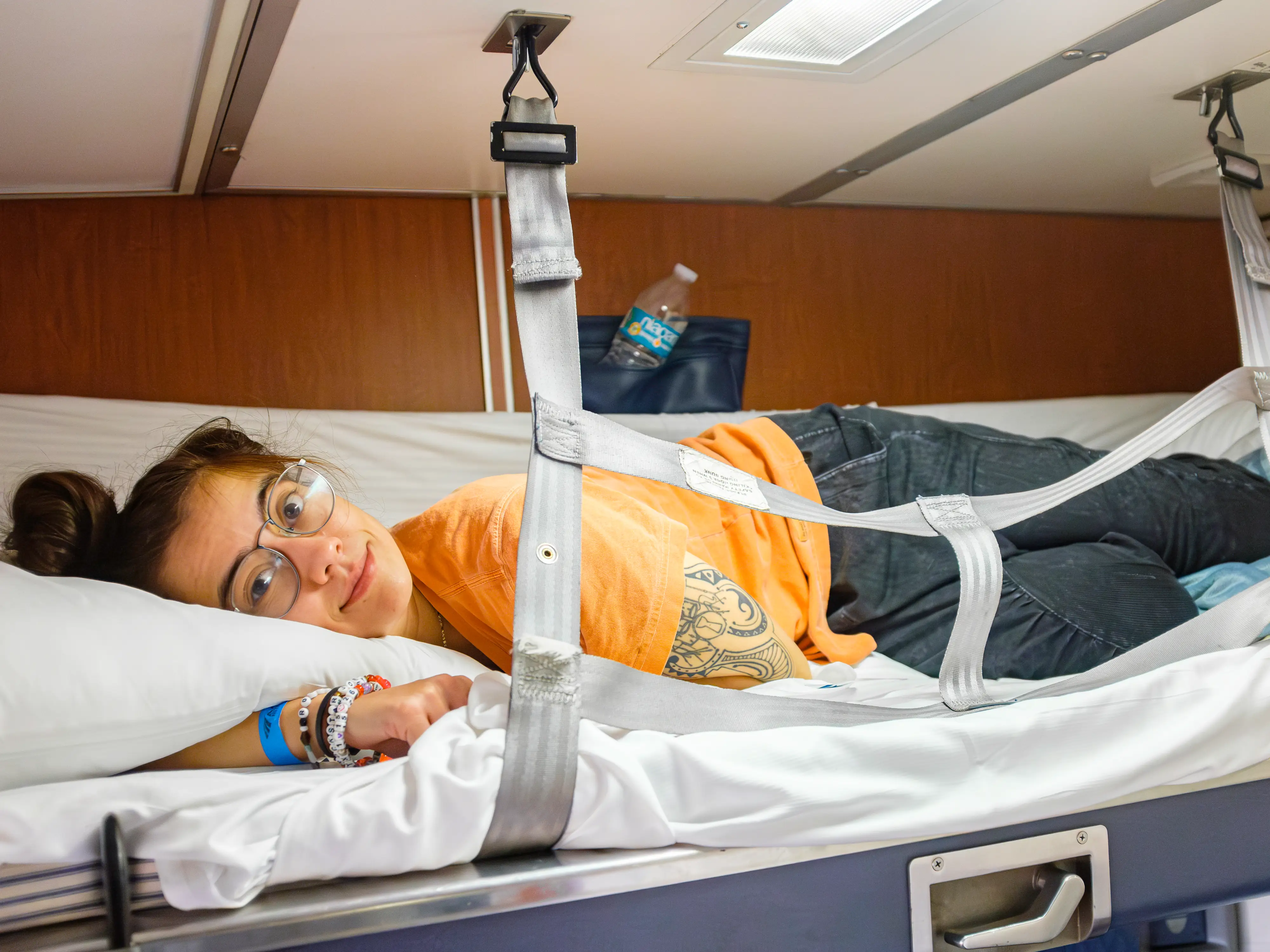 The author lays in the top bunk of an Amtrak bedroom