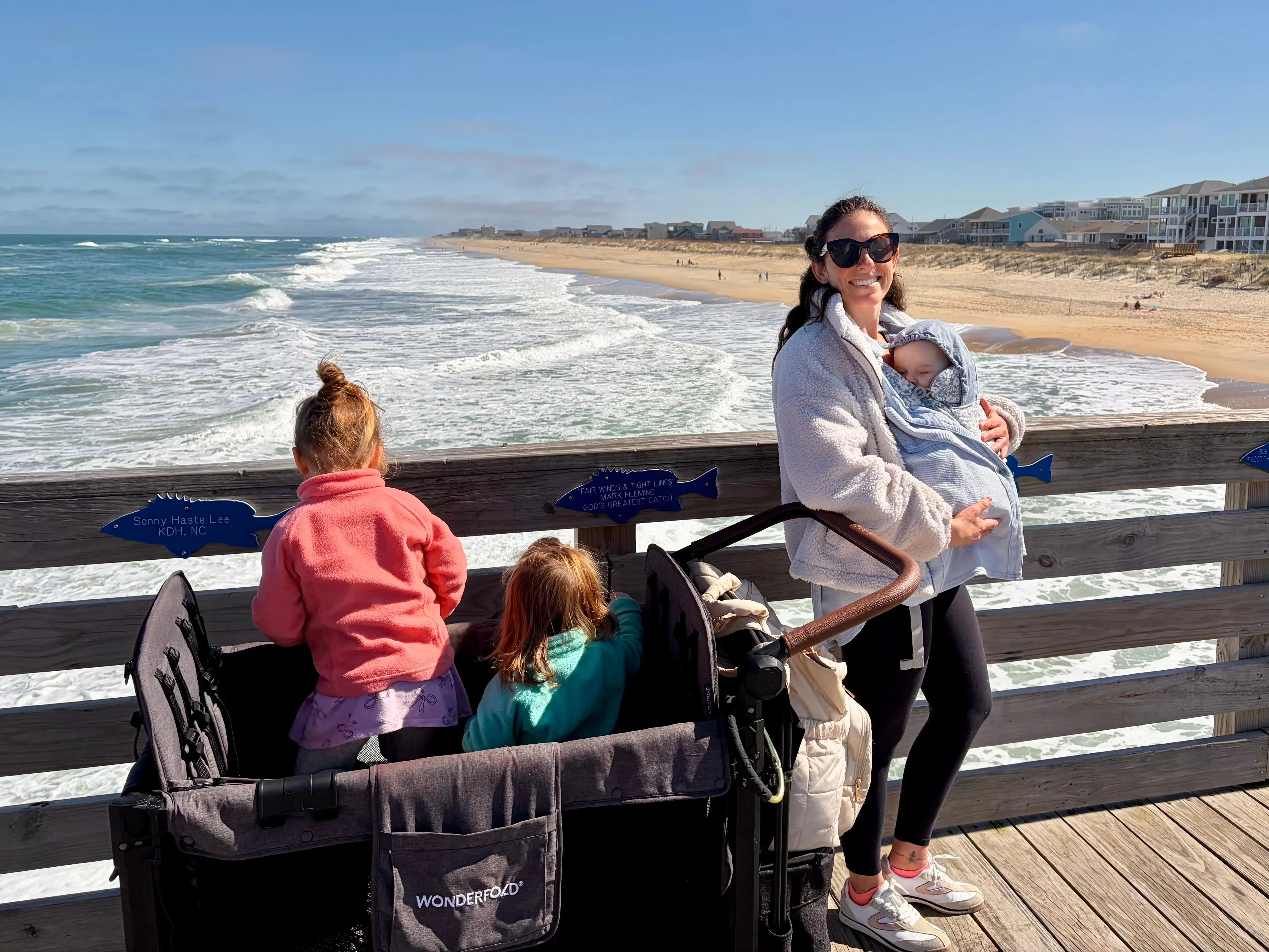 The author with her three kids on a wooden boardwalk.