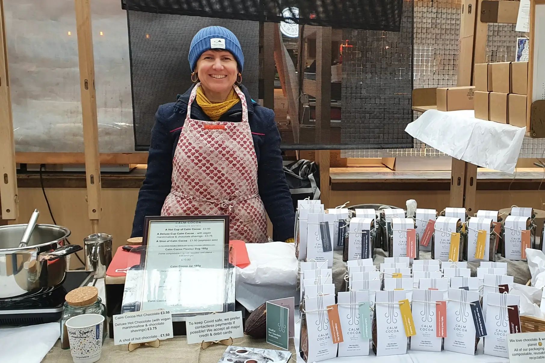 The writer bundled up at a stand, selling her chocolate and hot chocolate.