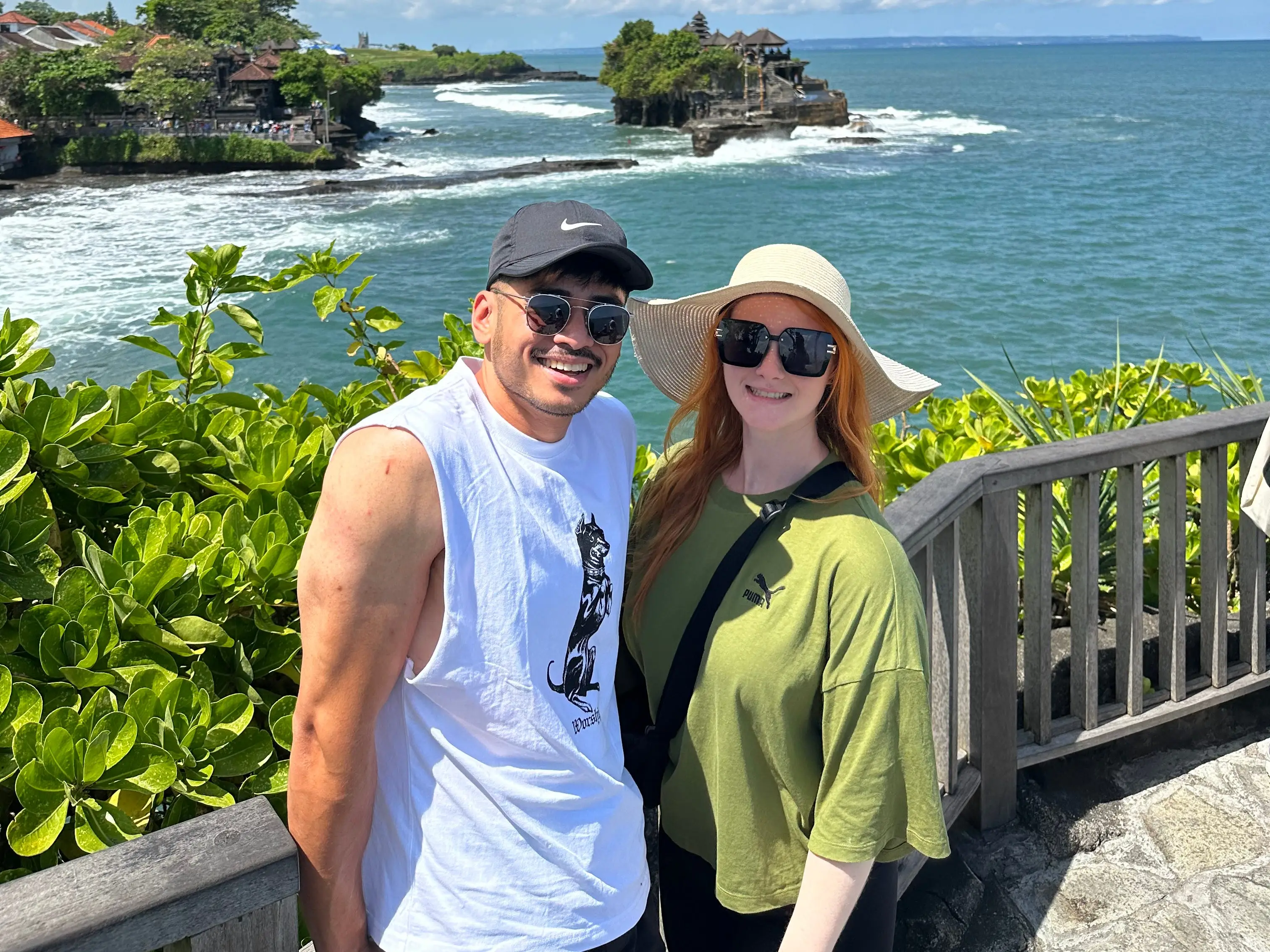 Man and woman posing in front of water