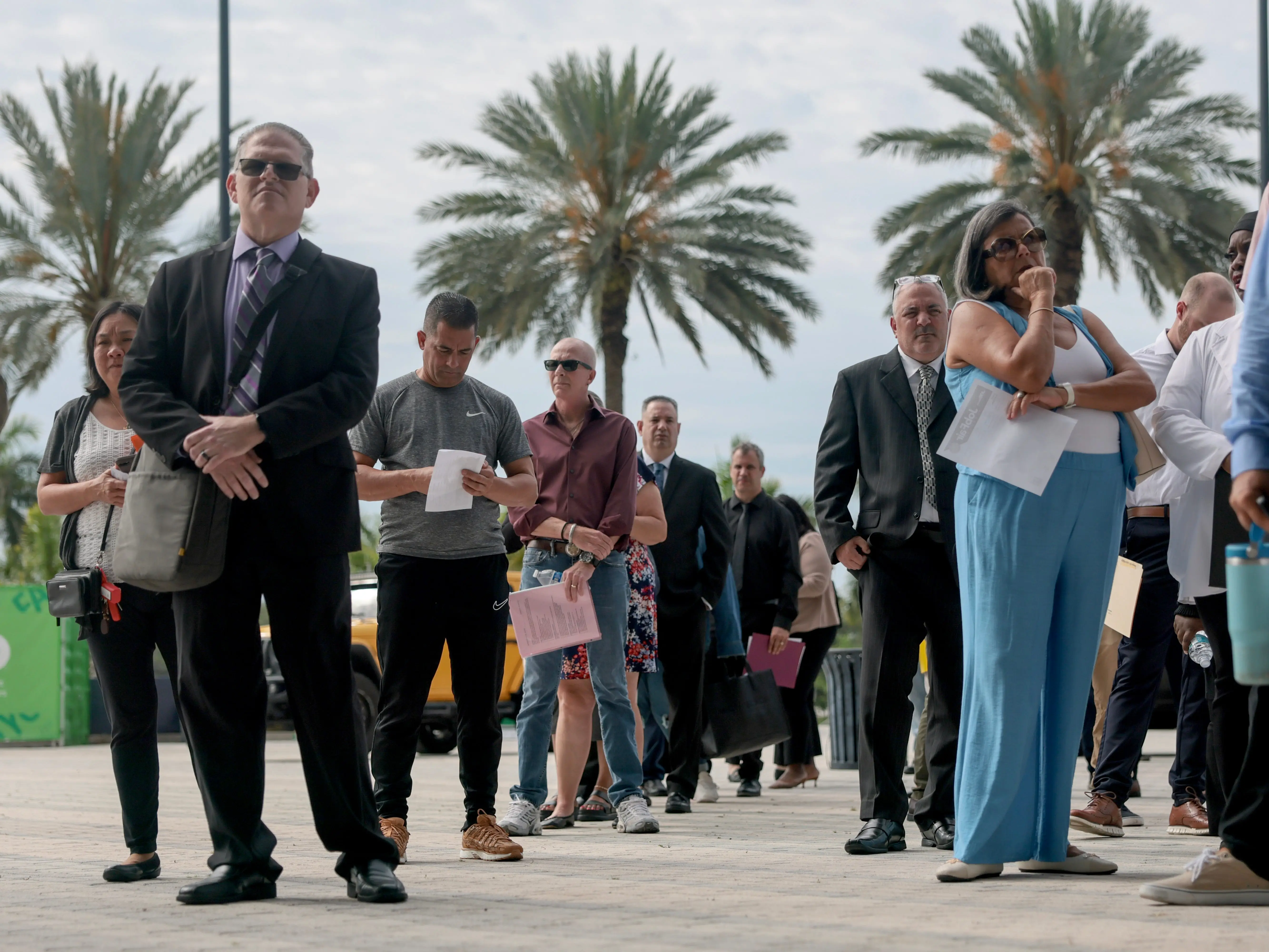 People wait in line at a Florida job fair