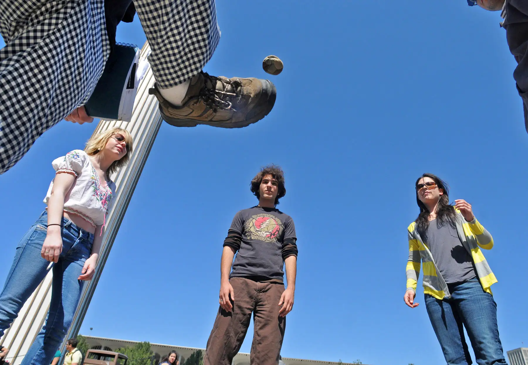 group playing hacky sack
