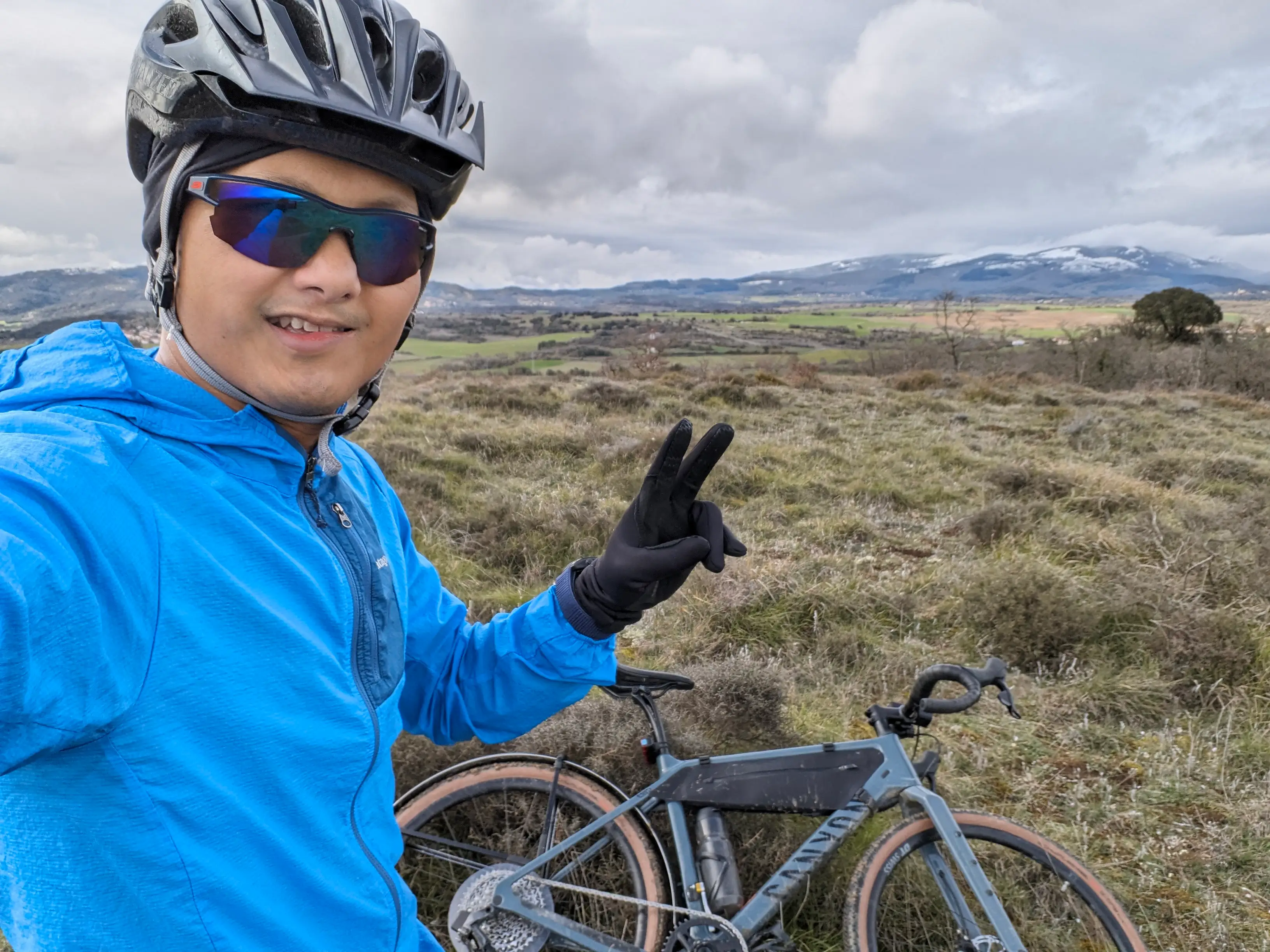 A man wearing a bike helmet bike riding in Spain.
