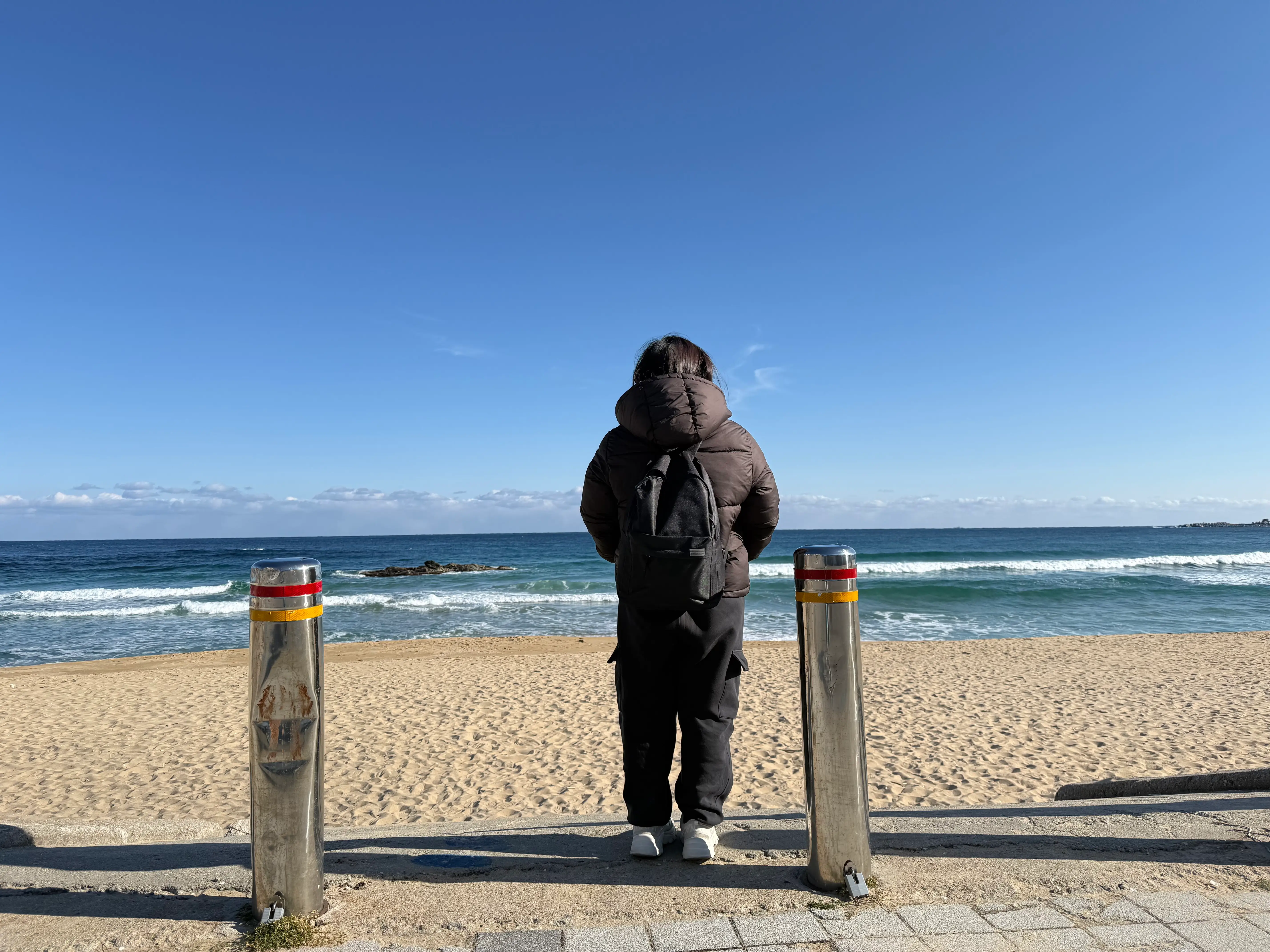 A woman facing the beach in South Korea.
