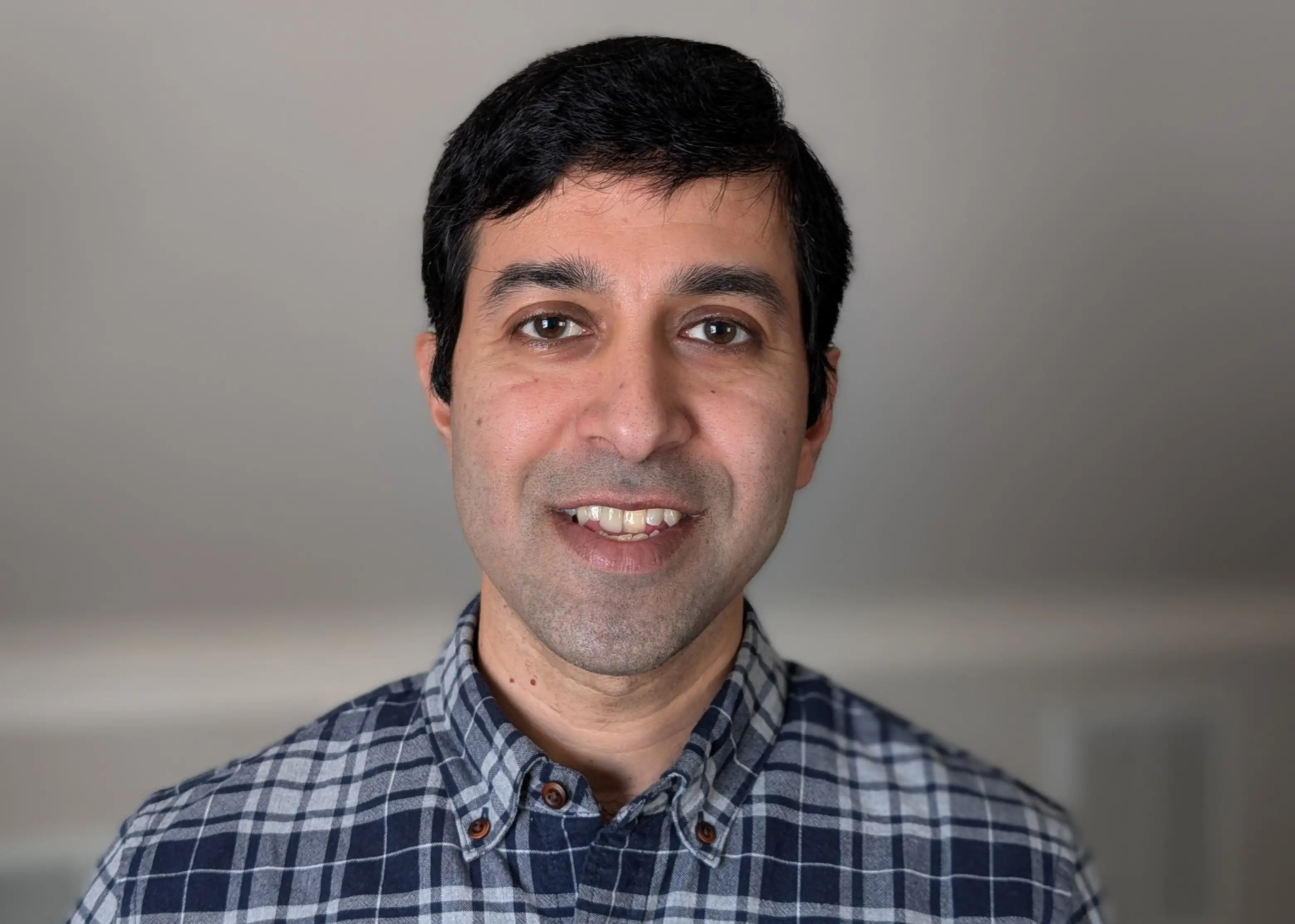 Anand Ramanthan is wearing a blue chequered shirt.