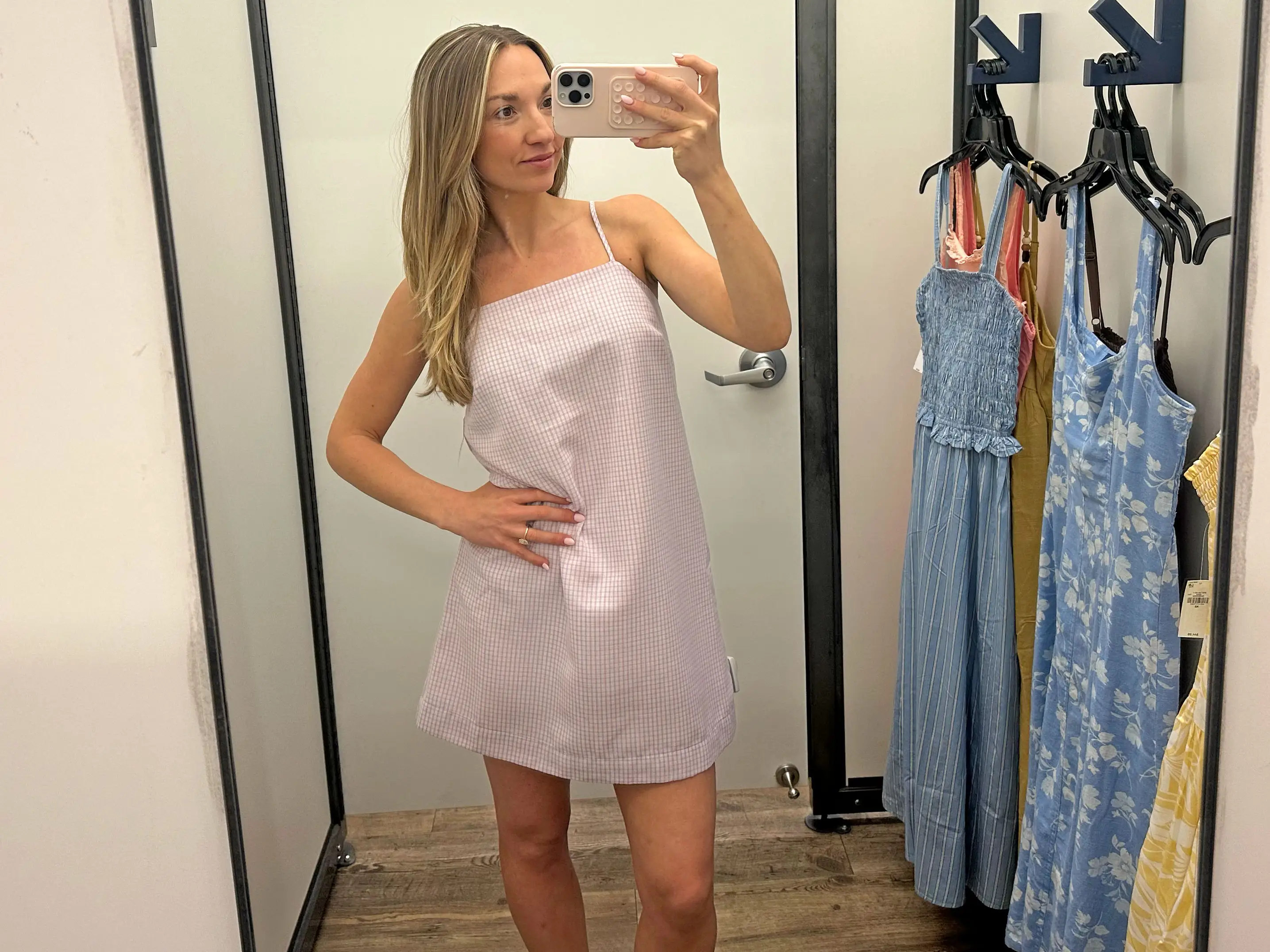 Chloe wears a purple gingham mini dress.