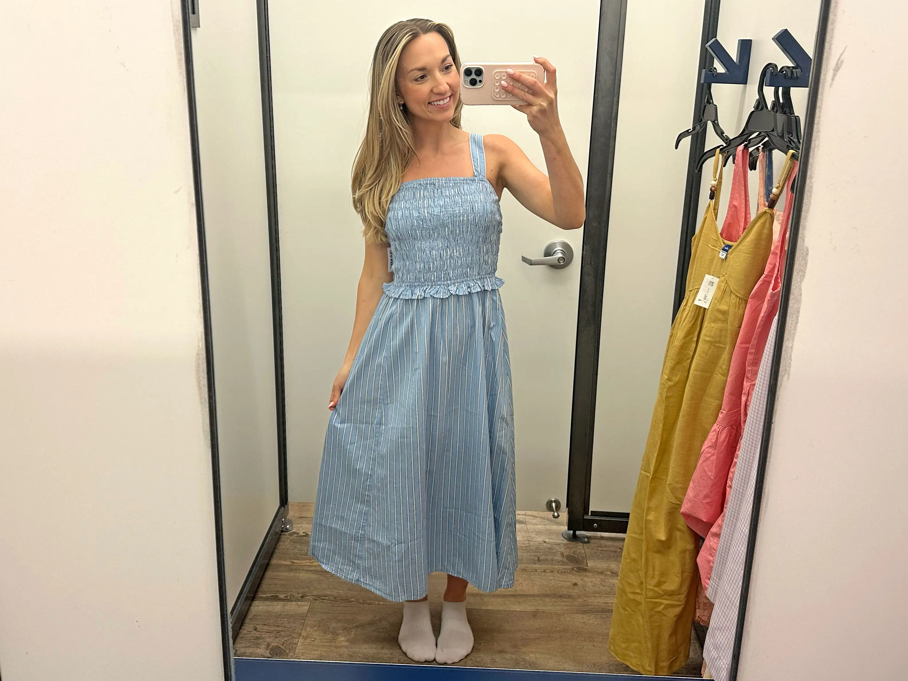 Chloe wears a blue-and-white striped midi dress.
