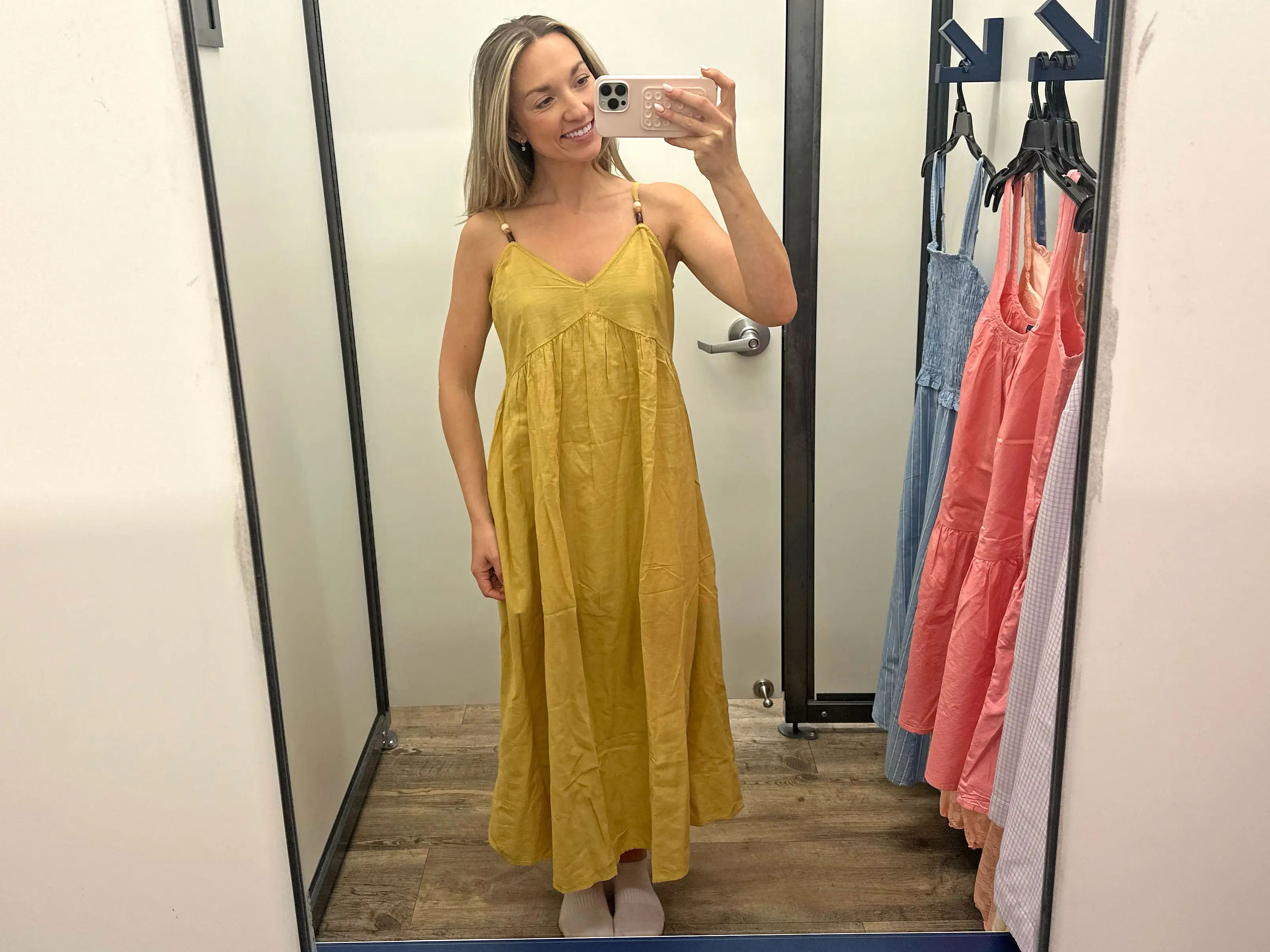 Chloe wears a yellow midi dress.