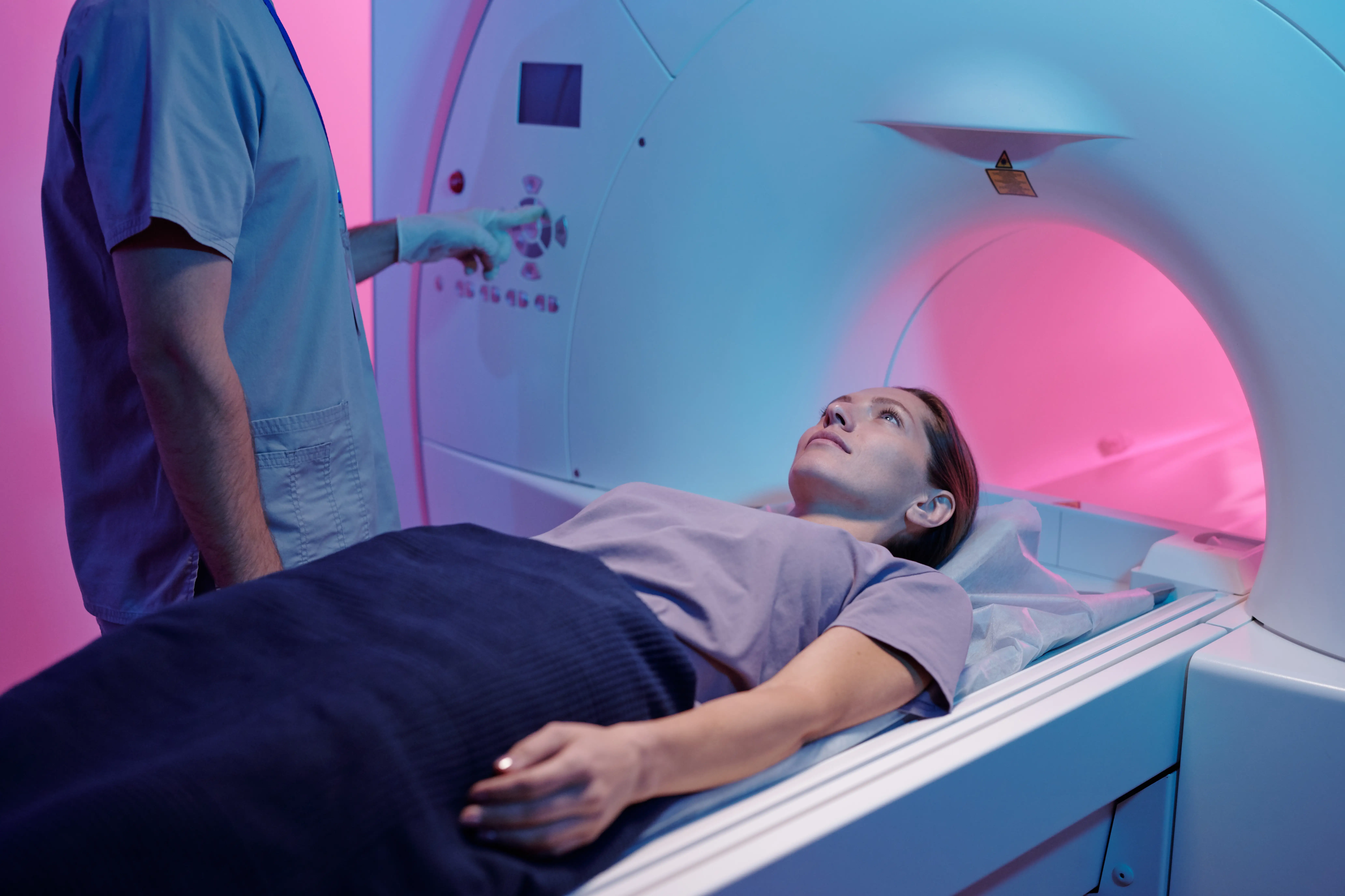 a young person laying on a medical table for an MRI scan