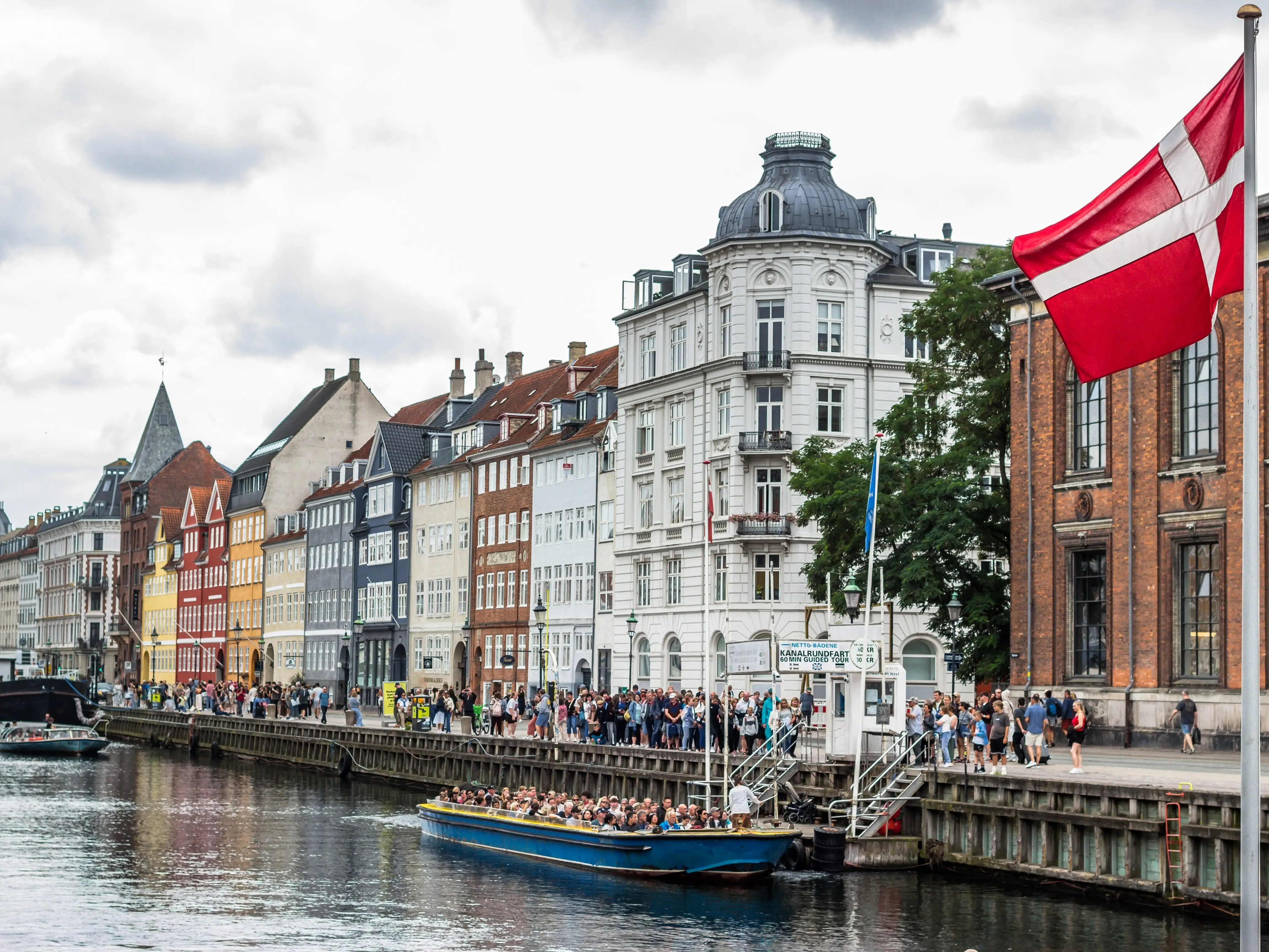 Boats on a waterway in front of buildings in Copenhagen, Denmark.