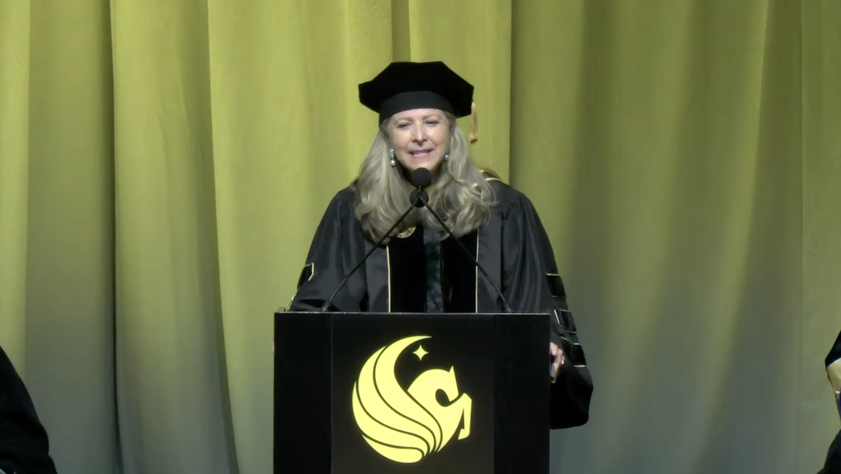 Gloria Caulfield speaks onstage at the University of Central Florida's Spring 2026 Commencement.