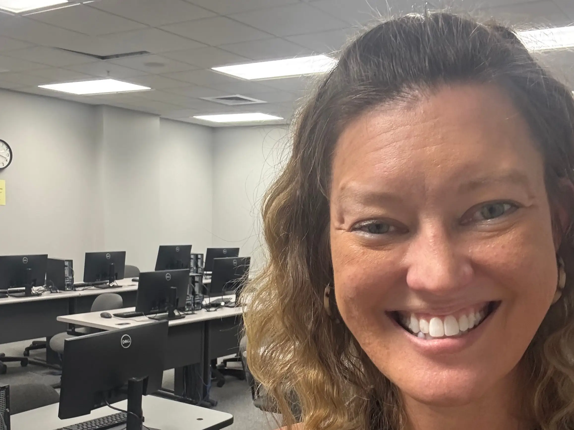 The author poses in a college classroom where she teaches.