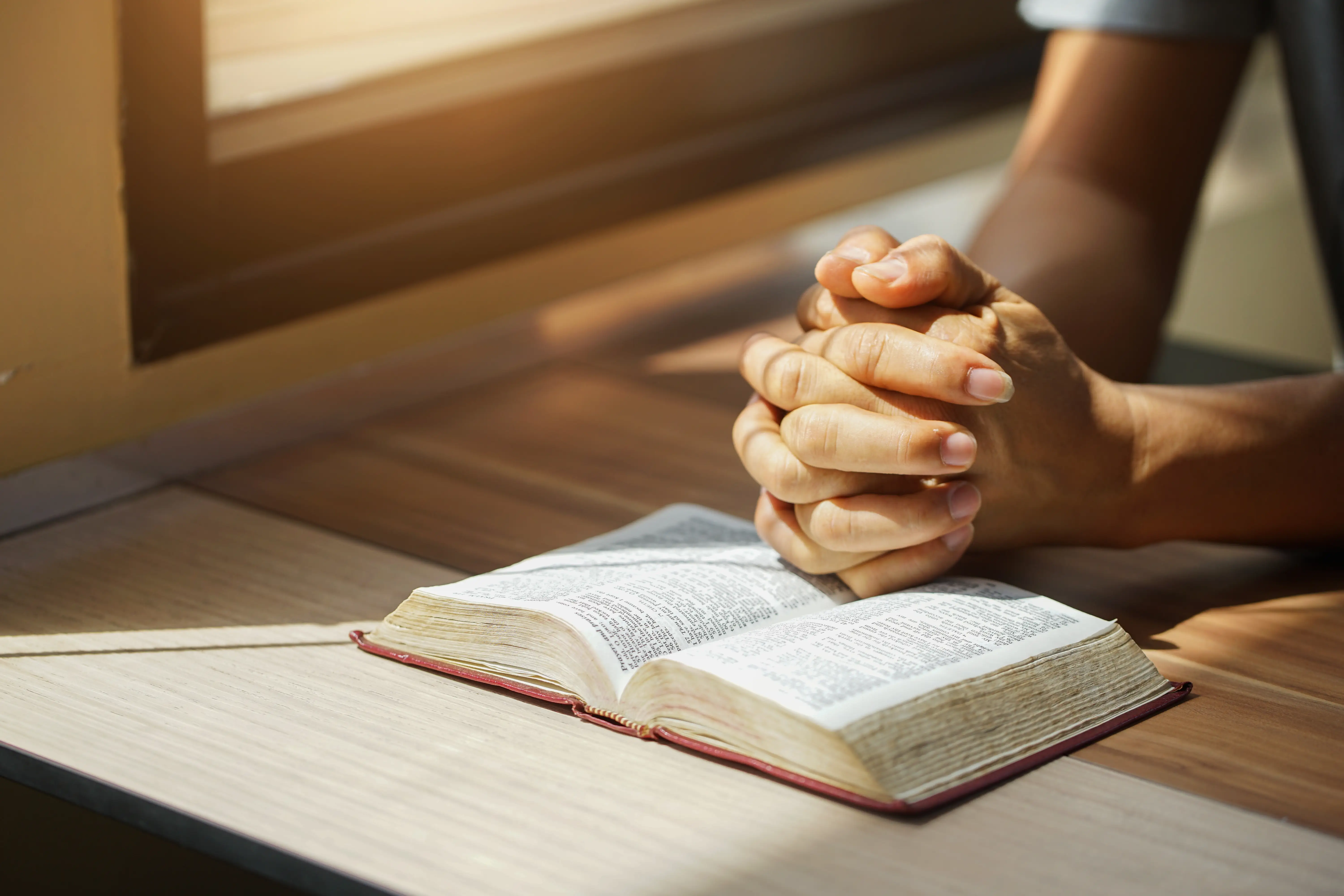 A man reading the Bible is pictured.