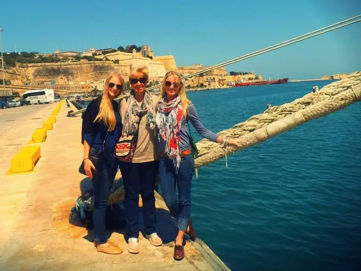 The author pictured at a port with her mom and sister.