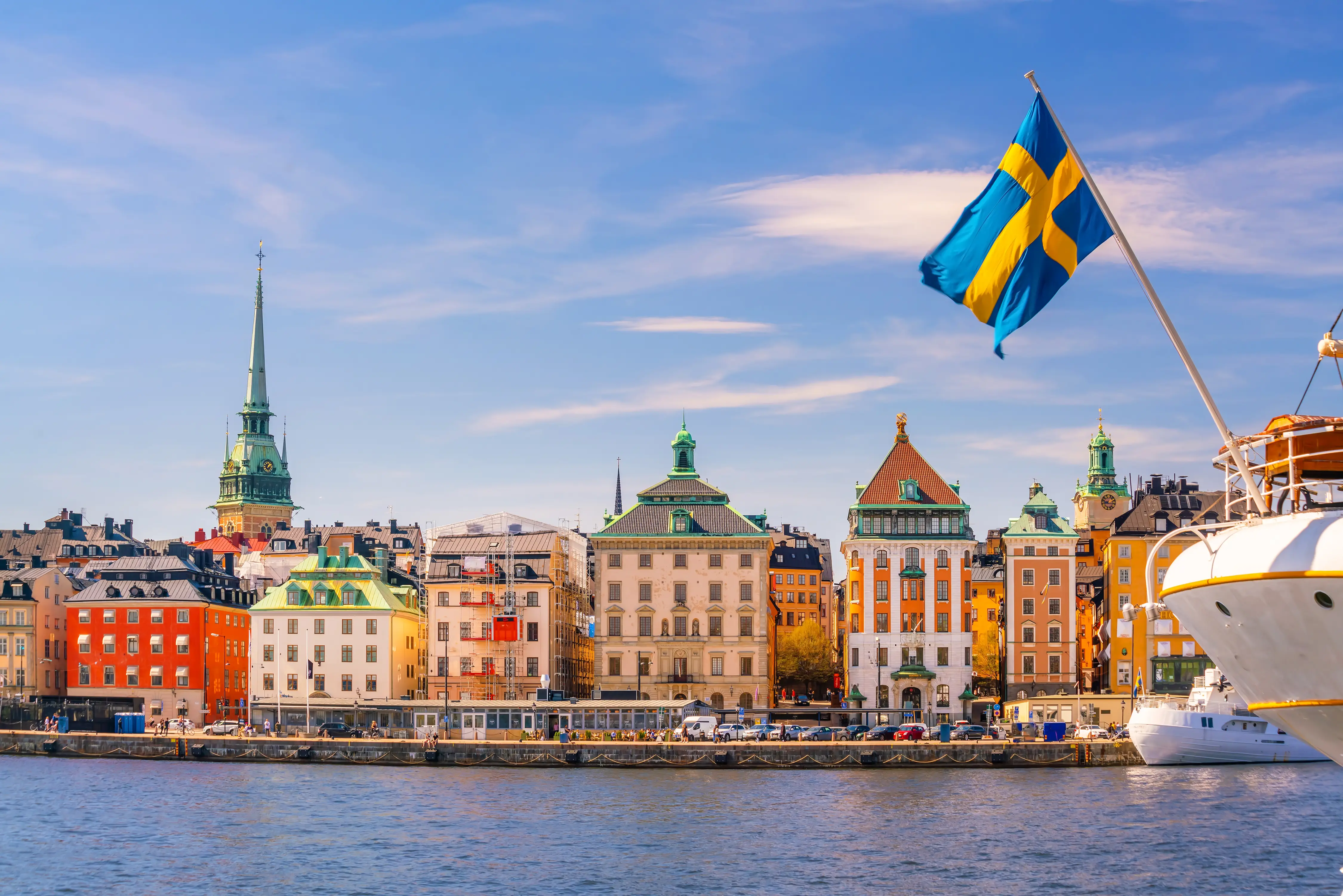 A view of the river in Stockholm: a boat with the Swedish flag.