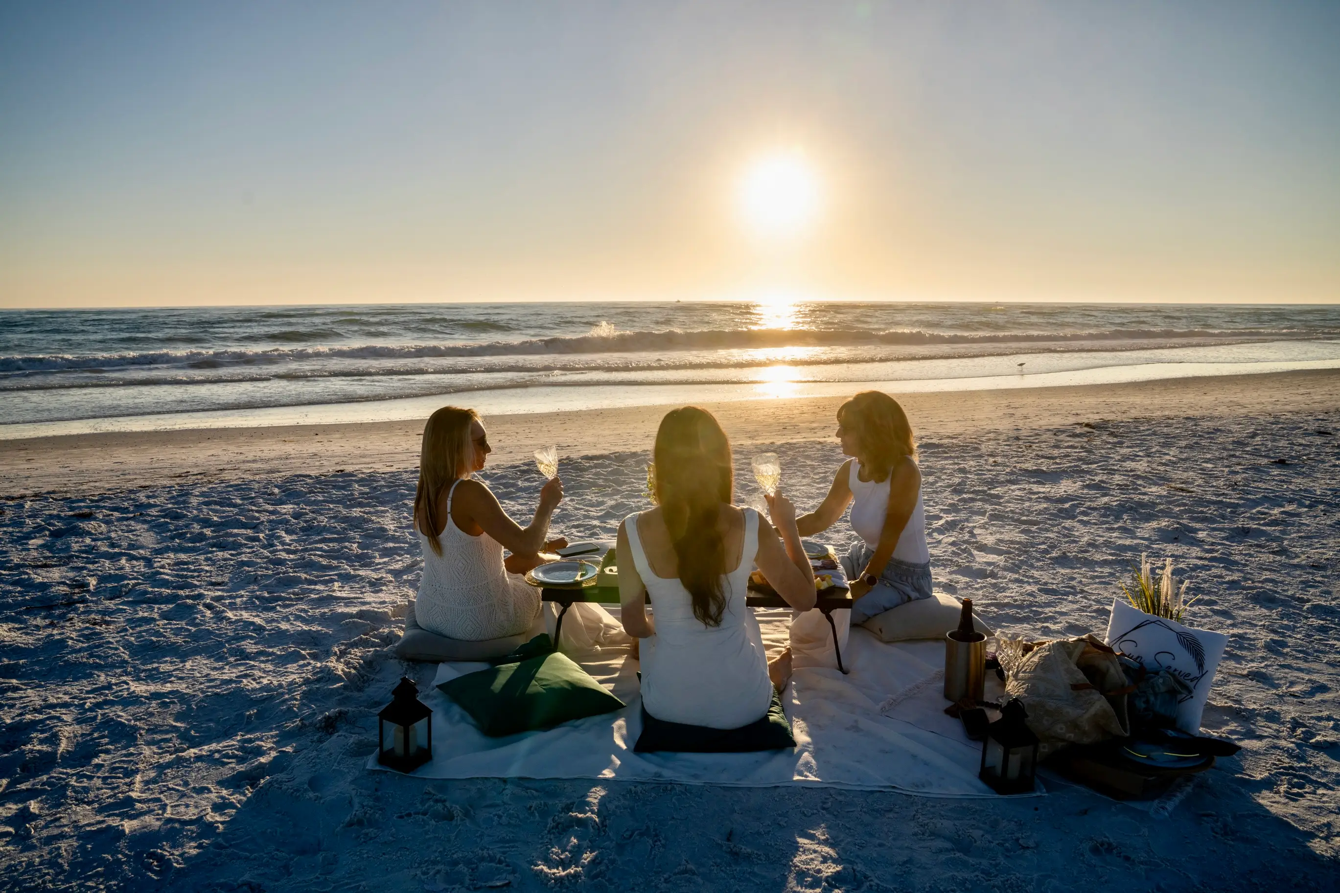 Three women having picnic on beach