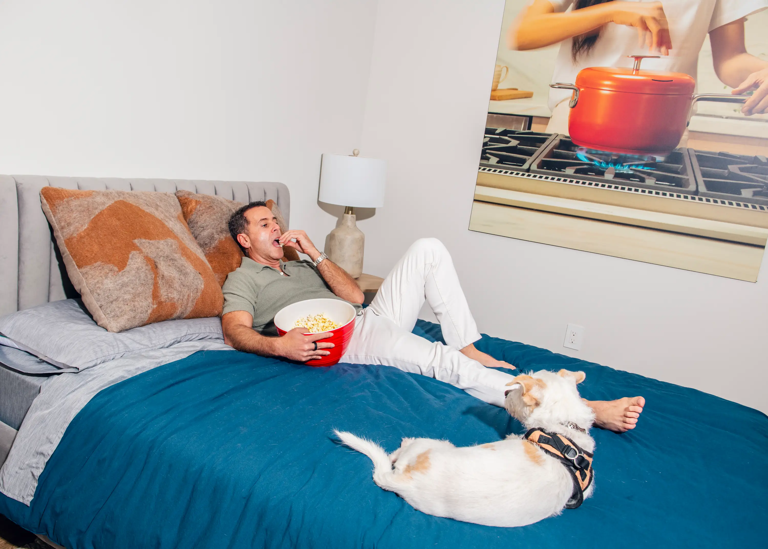 Tal Moore, Founder of Popsmith, lies in bed eating popcorn.