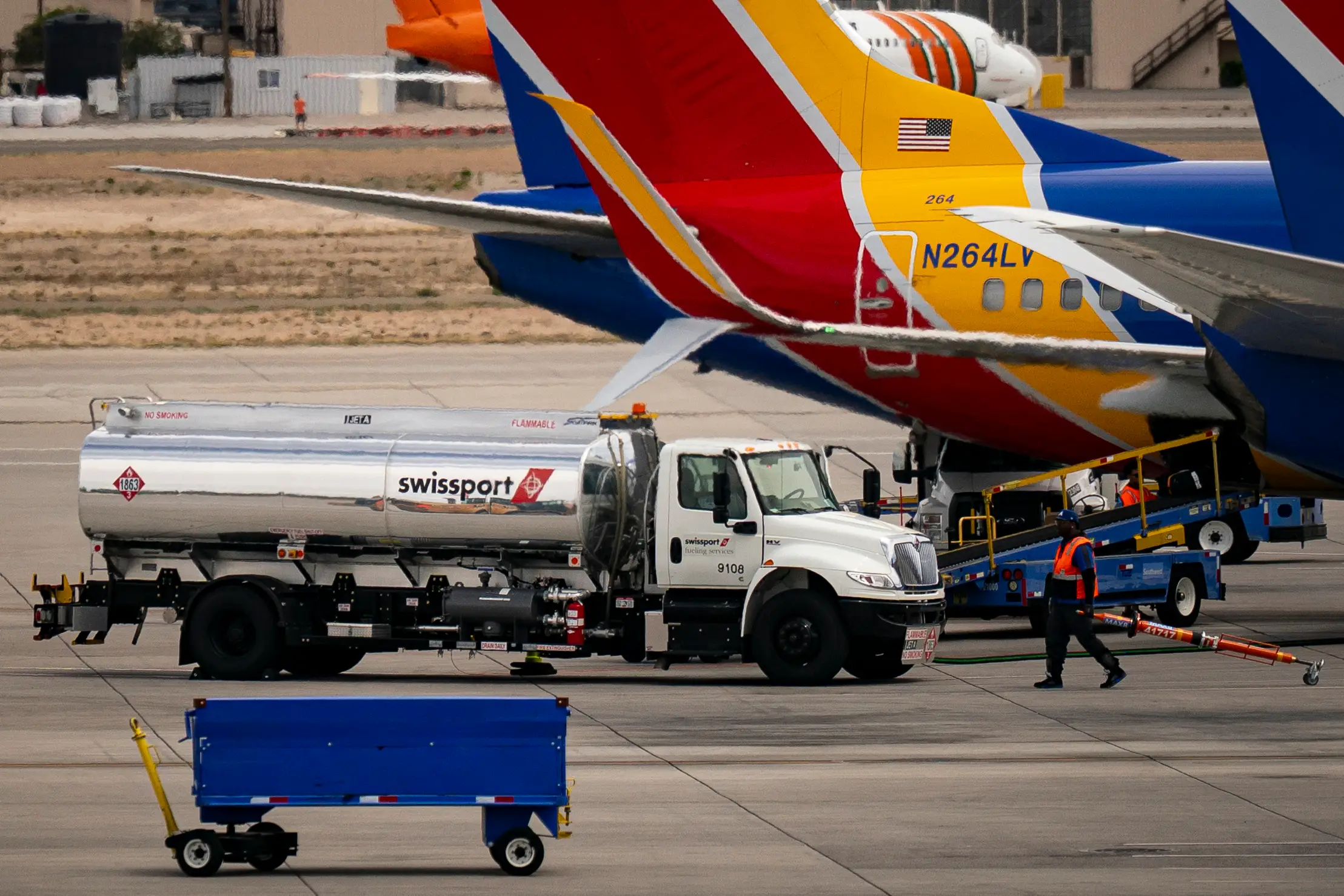 A swissport fuel truck fueling a southwest plane.
