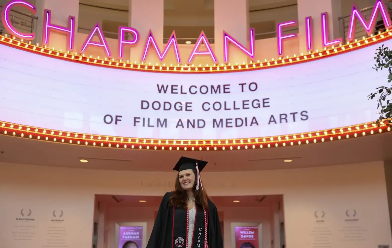 Lauren Trippeer in front of a chapman film sign on her college campus